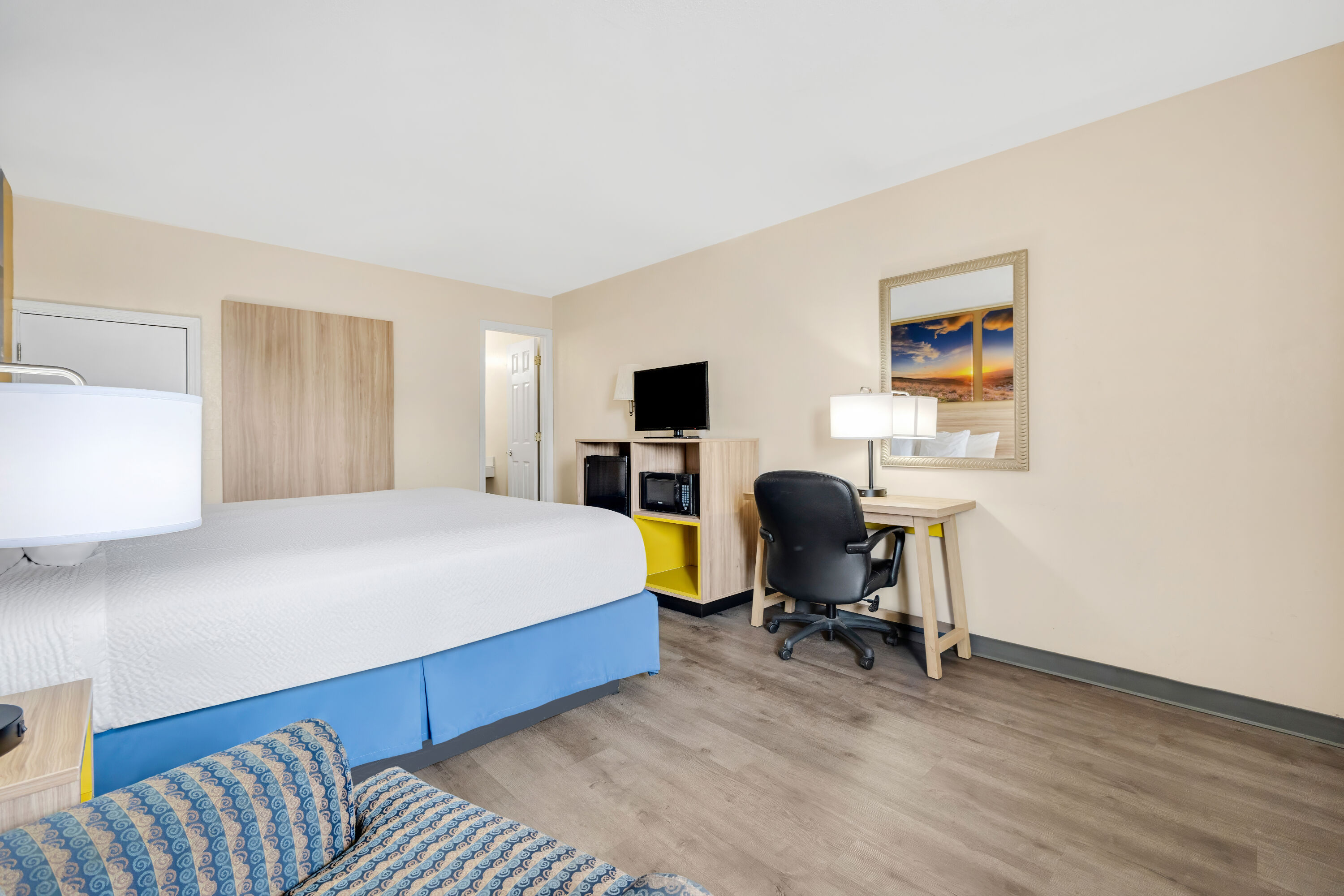 King bed guest room at the Days Inn by Wyndham Fort Wayne in Fort Wayne, Indiana