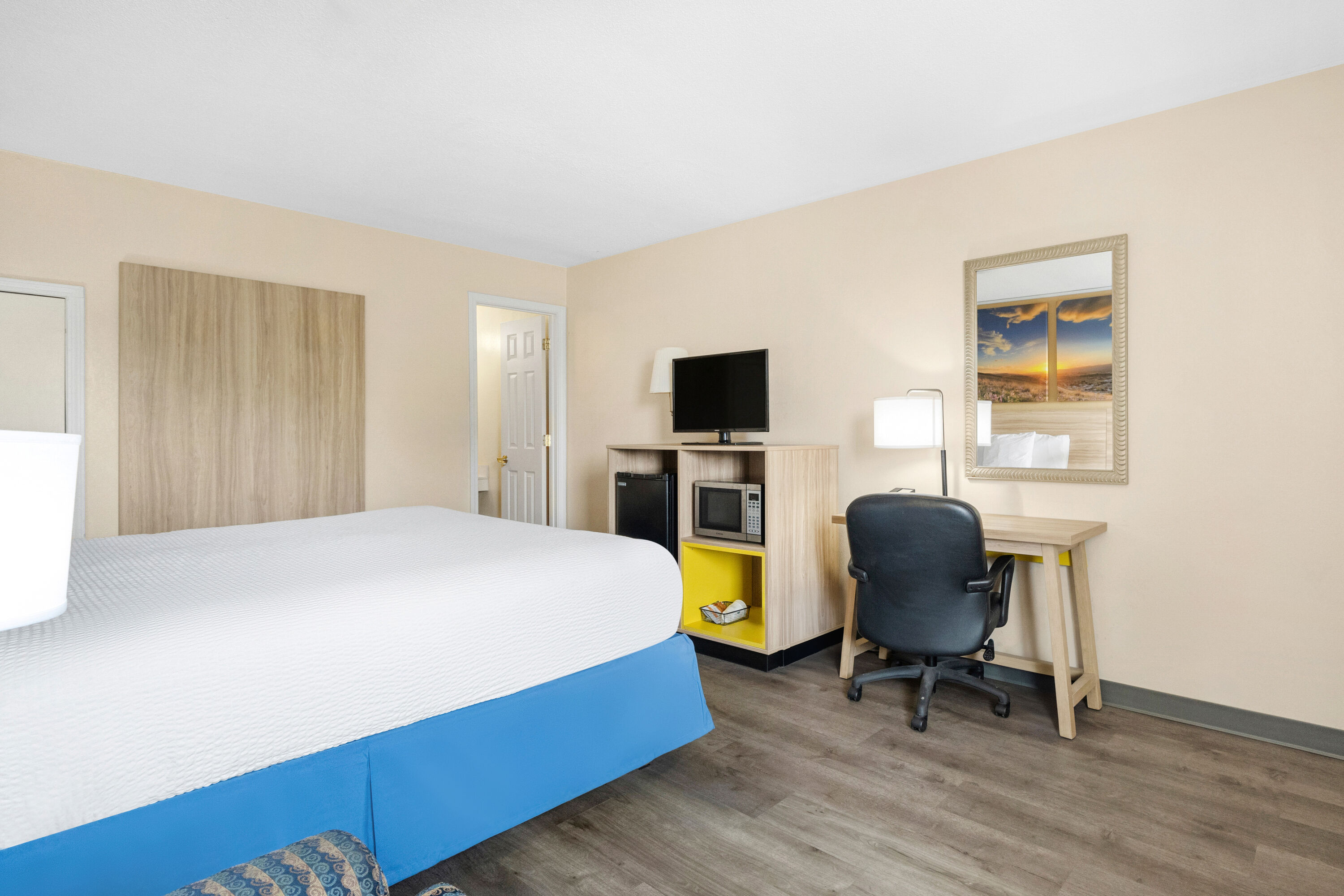 King bed guest room at the Days Inn by Wyndham Fort Wayne in Fort Wayne, Indiana