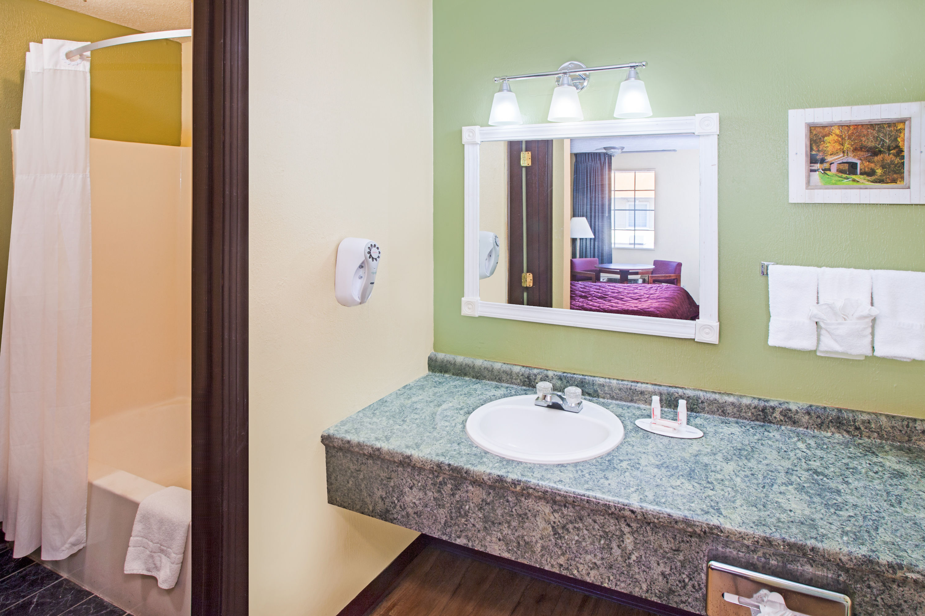Guest room bath at the Days Inn & Suites by Wyndham Terre Haute in Terre Haute, Indiana