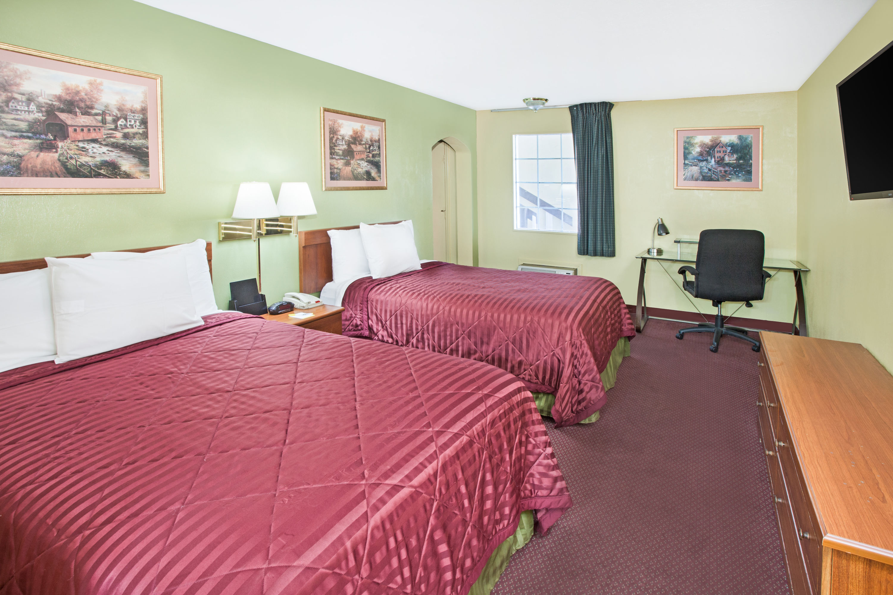 Guest room at the Days Inn & Suites by Wyndham Terre Haute in Terre Haute, Indiana