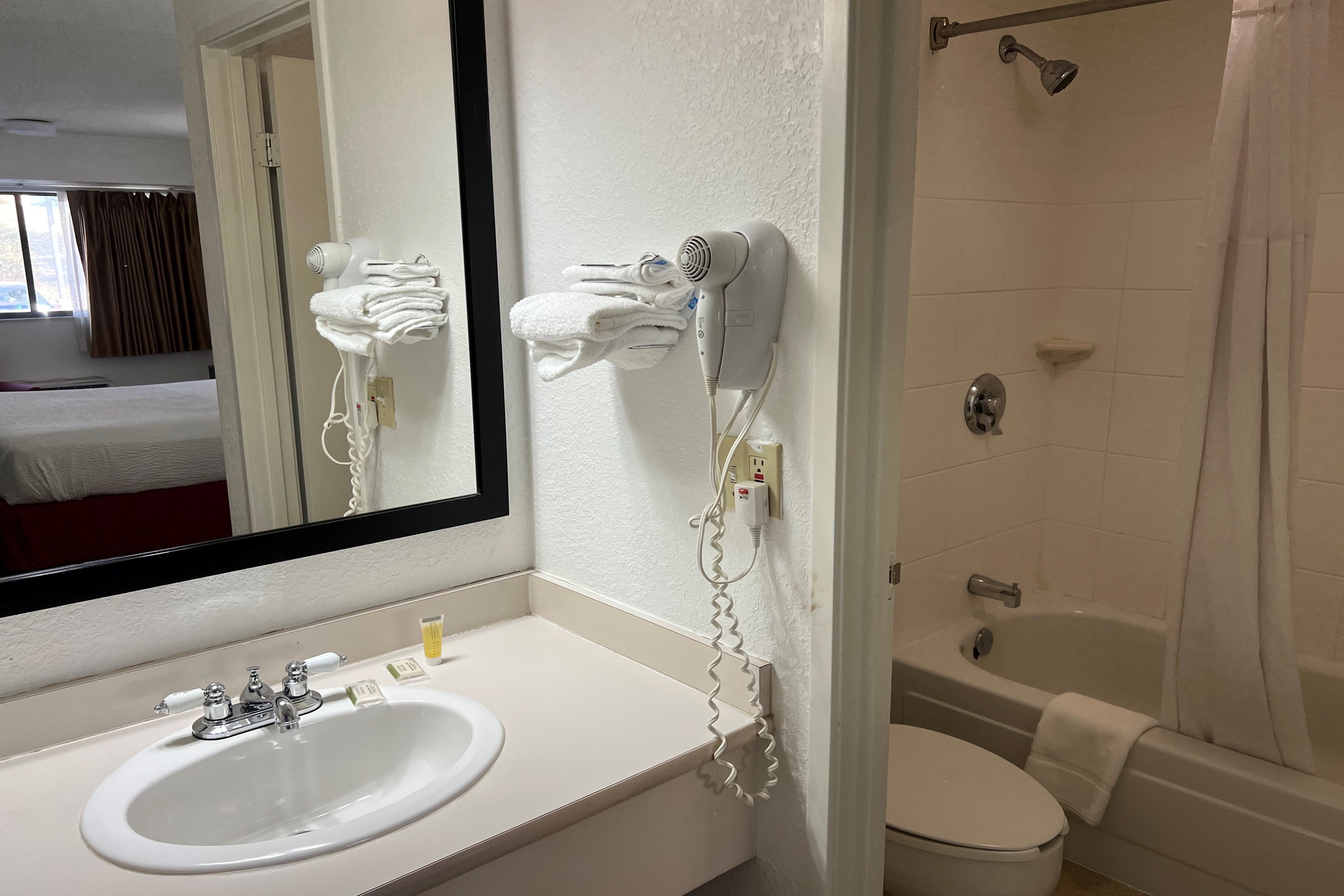 Guest room bath at the Days Inn by Wyndham Overland Park/Metcalf/Convention Center in Overland Park, Kansas
