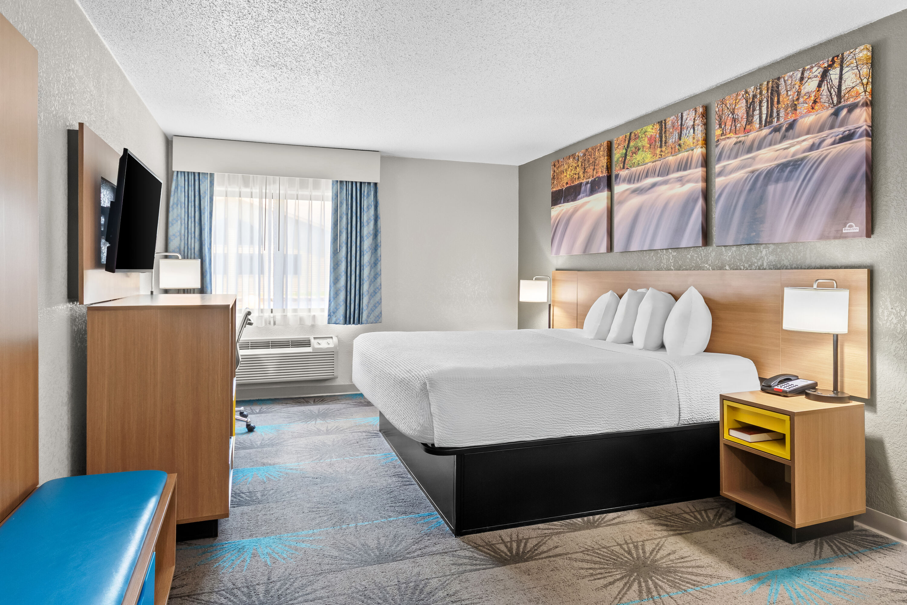 King bed guest room at the Days Inn by Wyndham Alpena in Alpena, Michigan