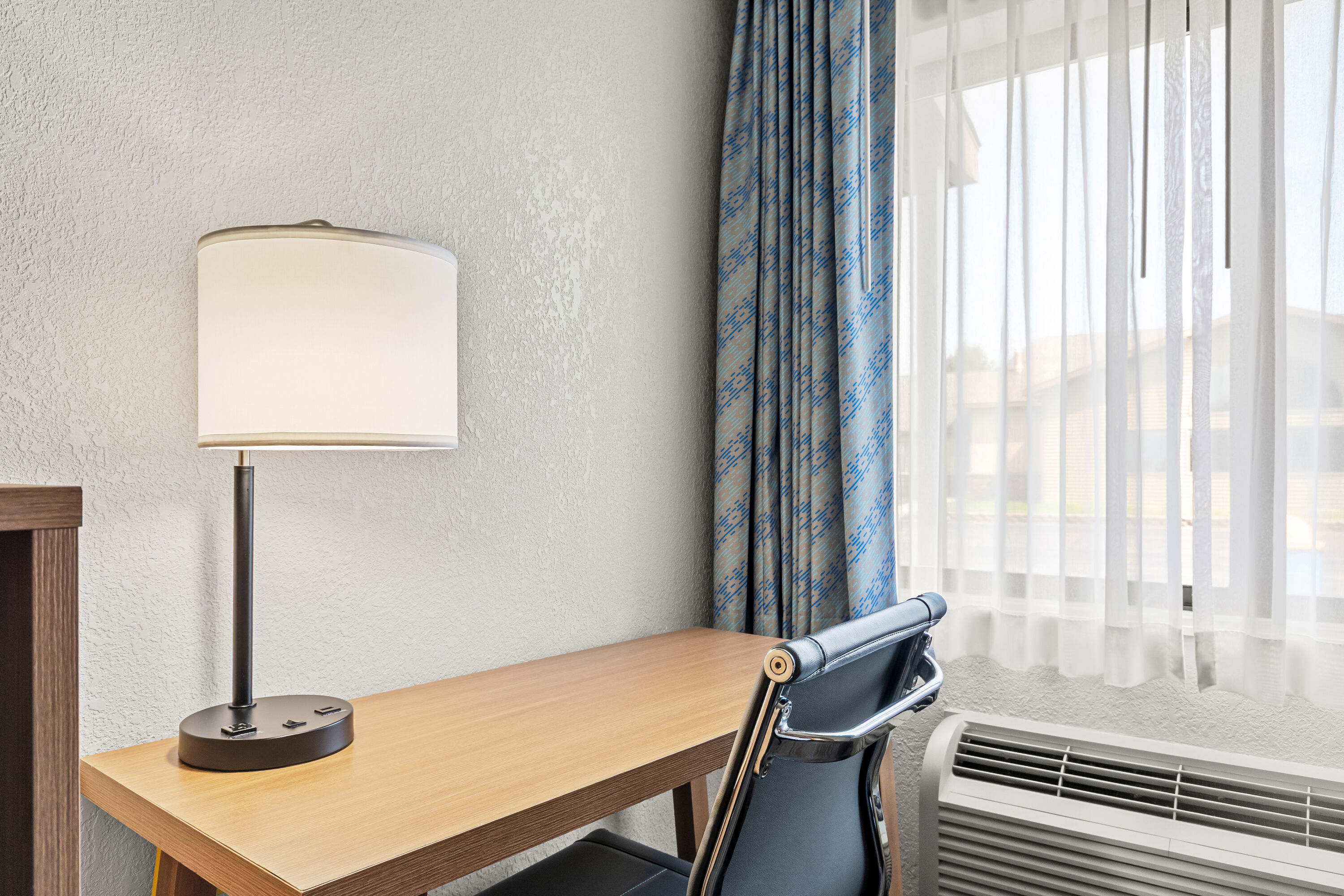 King bed guest room at the Days Inn by Wyndham Alpena in Alpena, Michigan