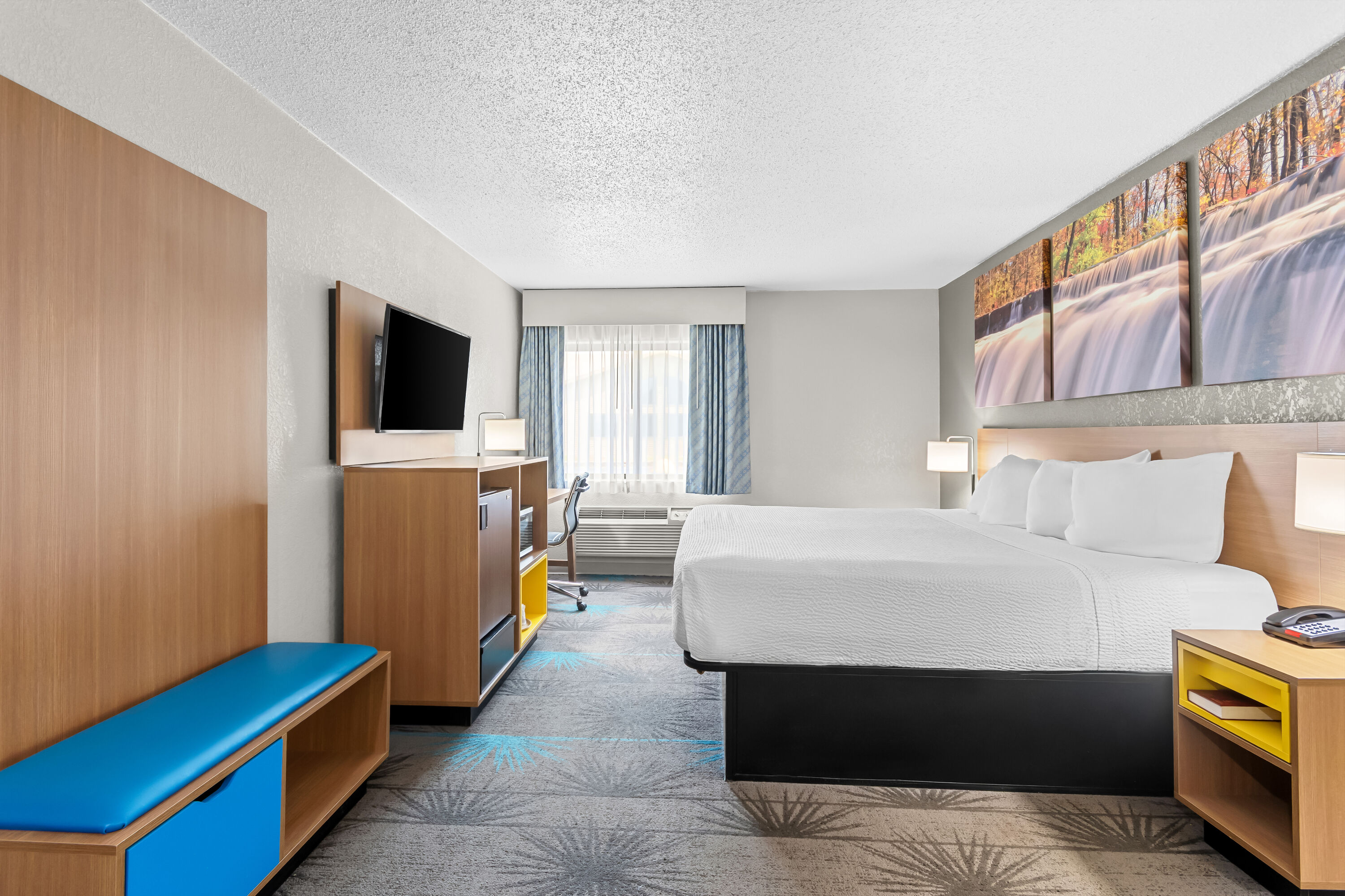 King bed guest room at the Days Inn by Wyndham Alpena in Alpena, Michigan