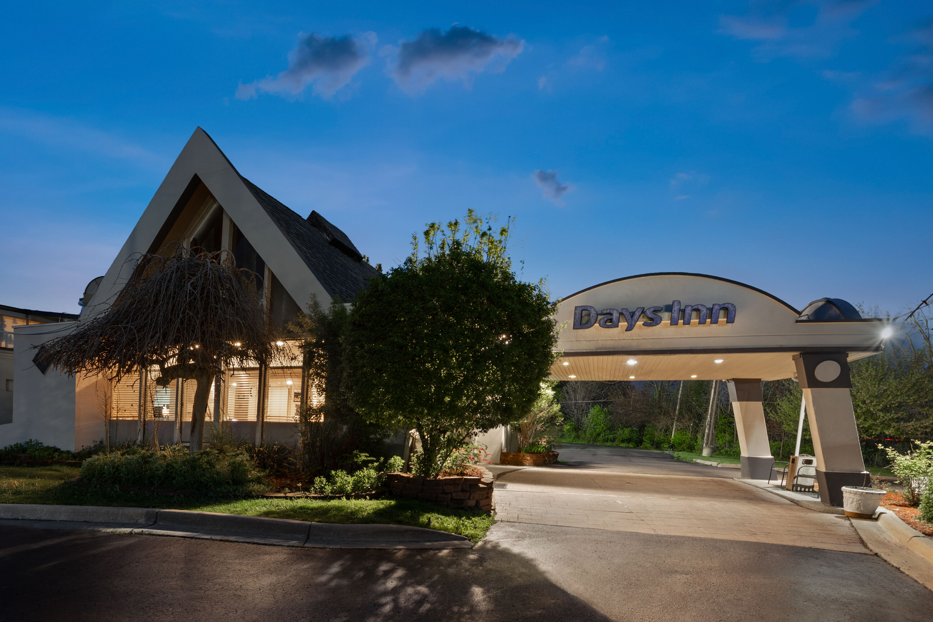 Exterior Dusk Image of Days Inn by Wyndham Ann Arbor hotel in Ann Arbor, Michigan