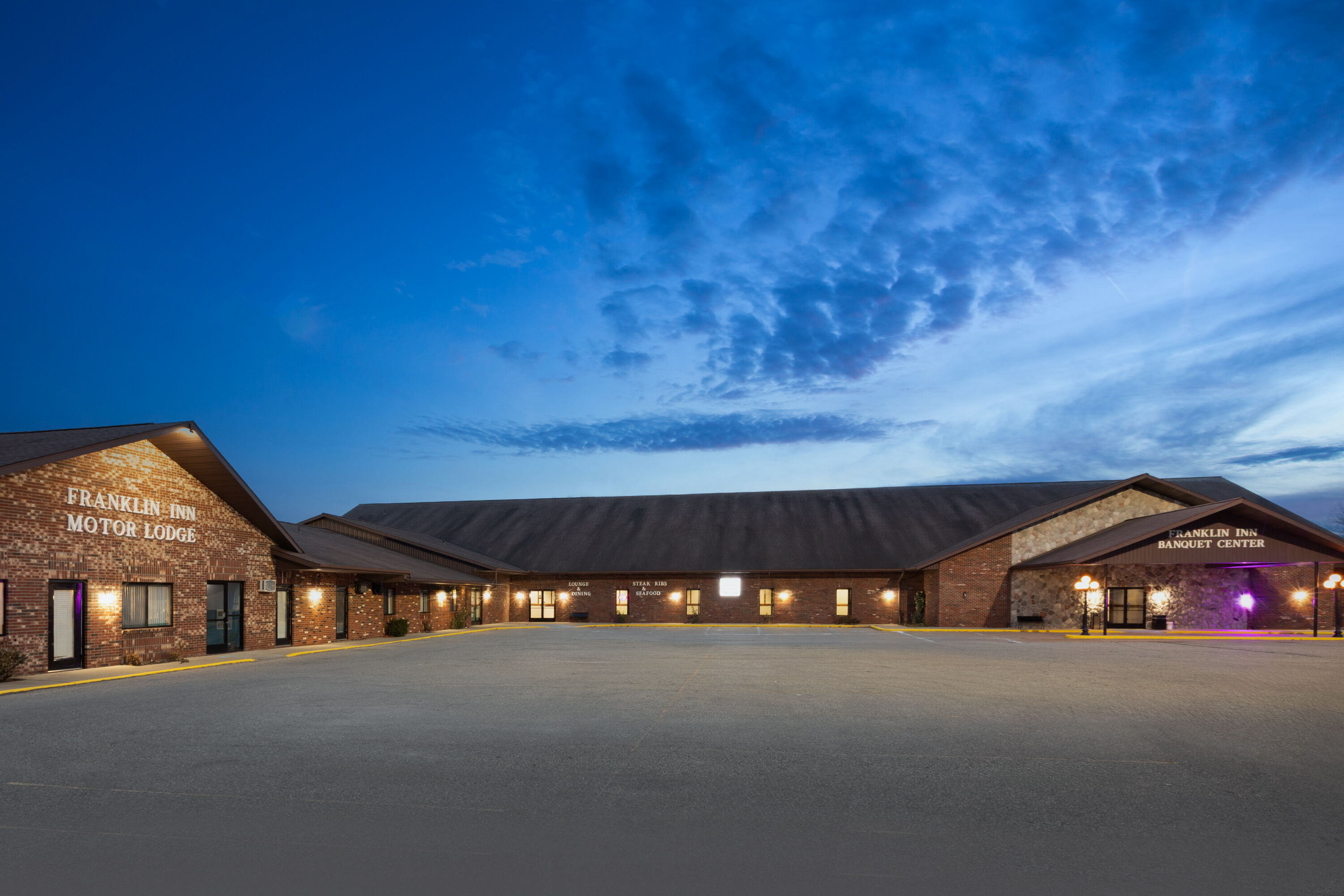 Exterior Dusk Image of Days Inn by Wyndham Bad Axe hotel in Bad Axe, Michigan