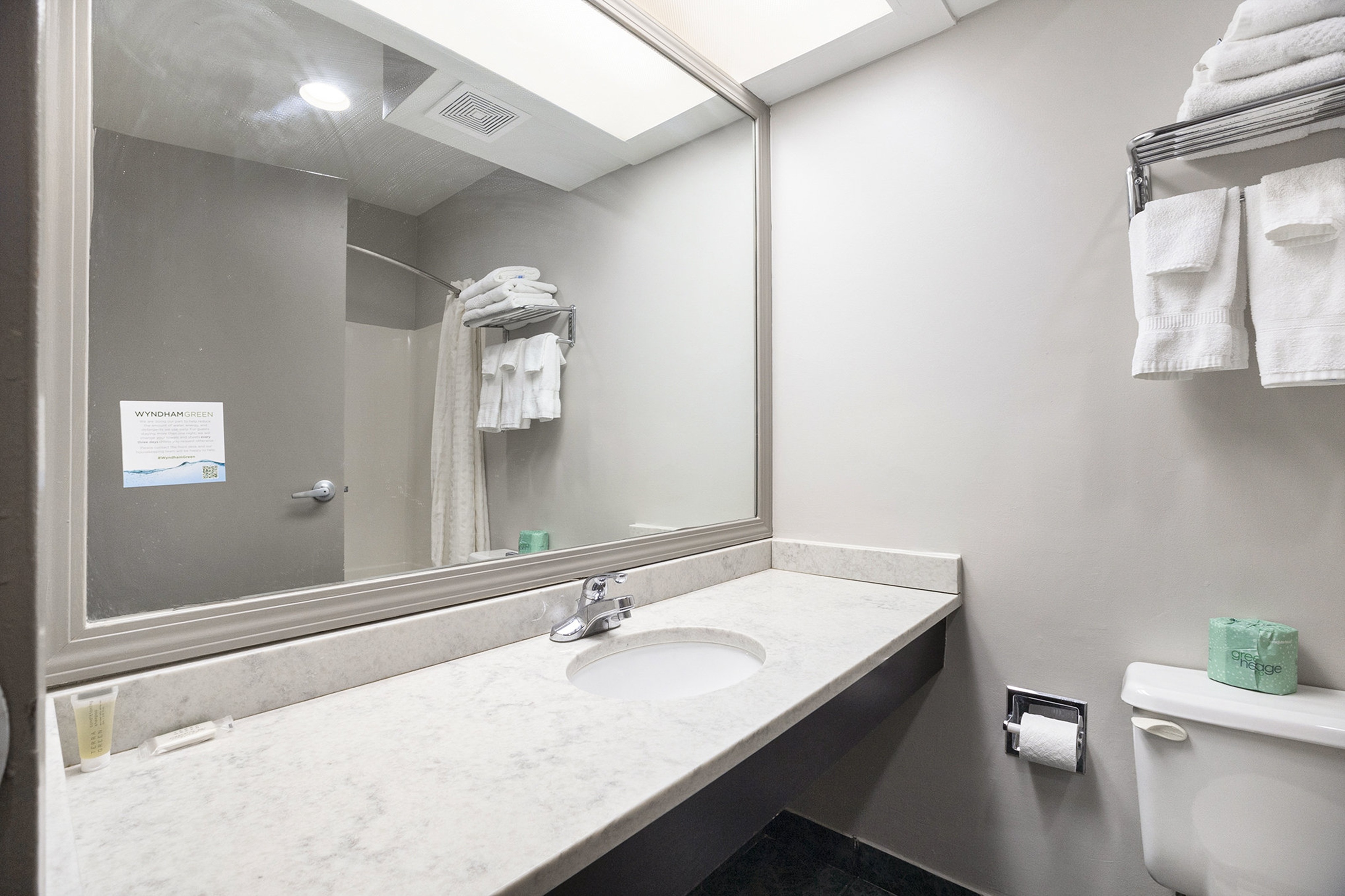 Guest room bath at the Days Inn & Suites by Wyndham Norton Shores/Muskegon in Norton Shores, Michigan