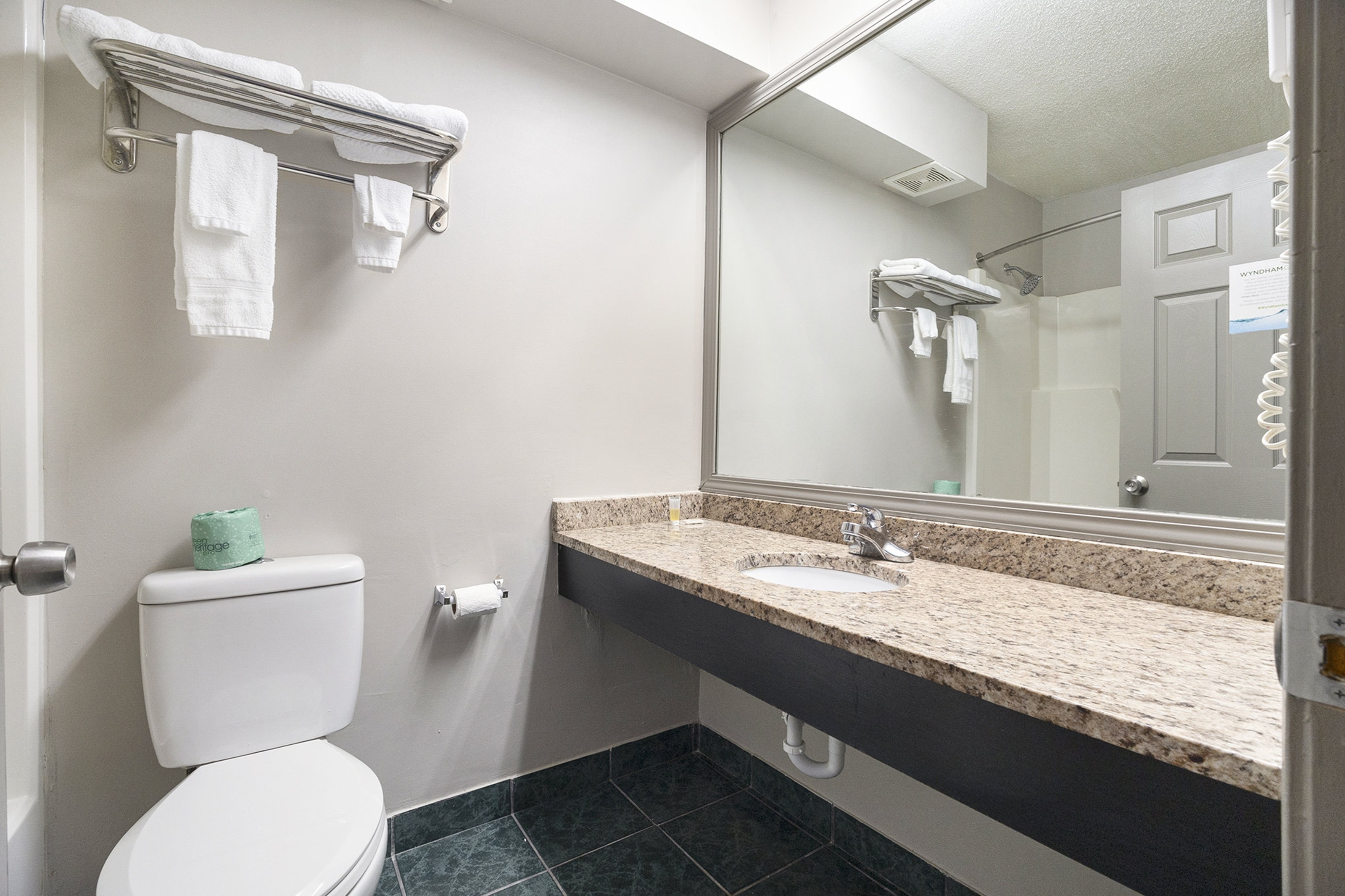 Guest room bath at the Days Inn & Suites by Wyndham Norton Shores/Muskegon in Norton Shores, Michigan