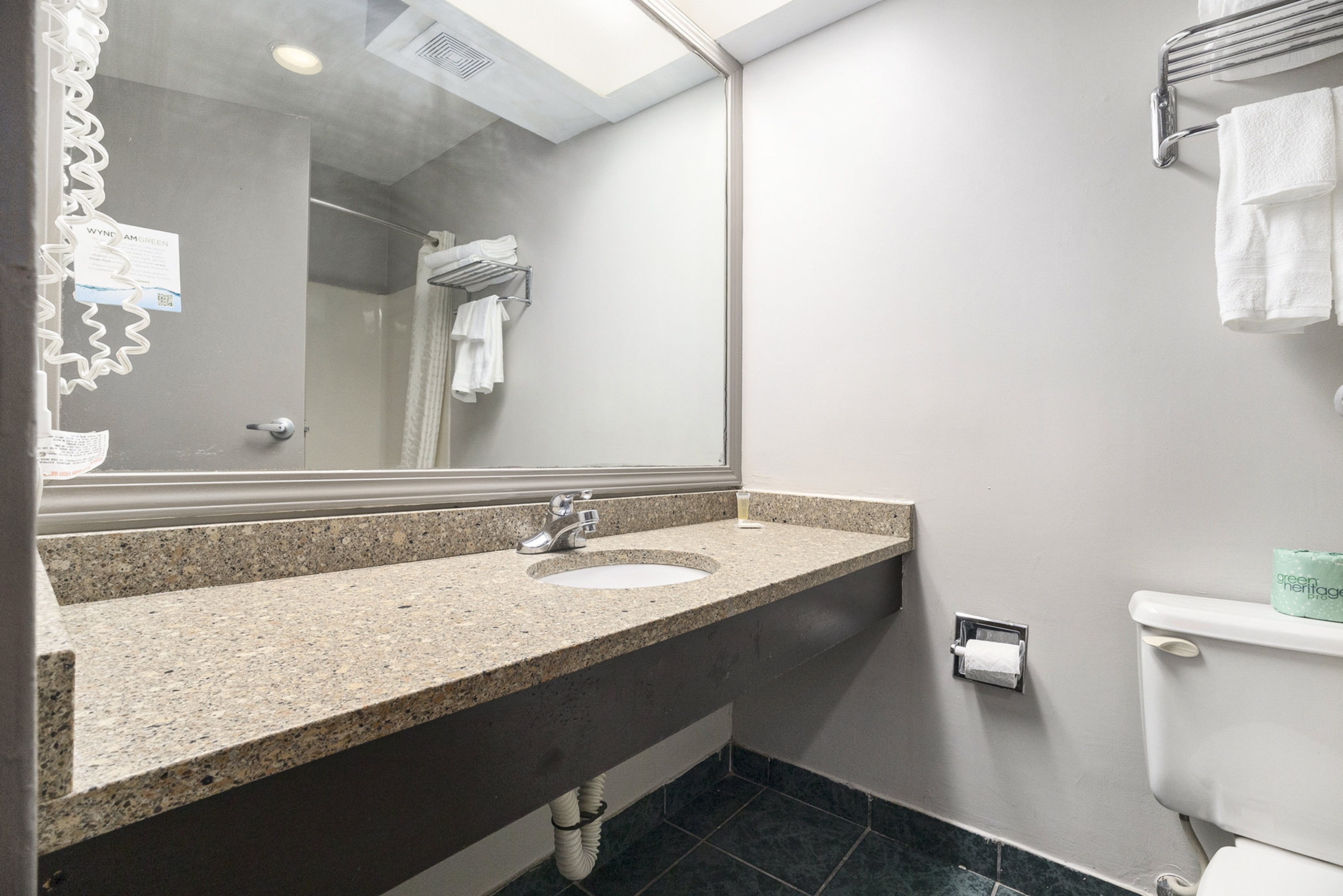 Guest room bath at the Days Inn & Suites by Wyndham Norton Shores/Muskegon in Norton Shores, Michigan