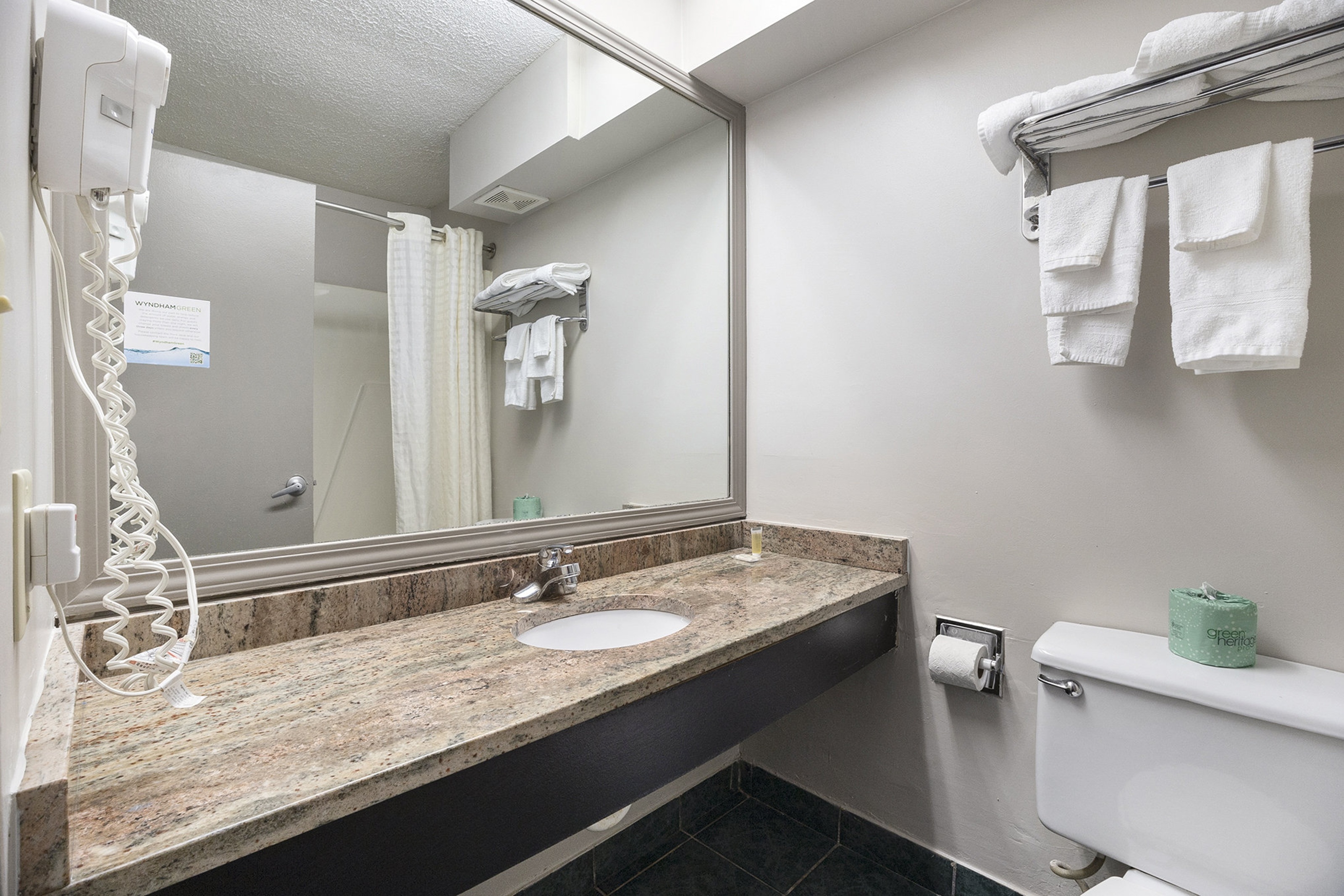 Guest room bath at the Days Inn & Suites by Wyndham Norton Shores/Muskegon in Norton Shores, Michigan