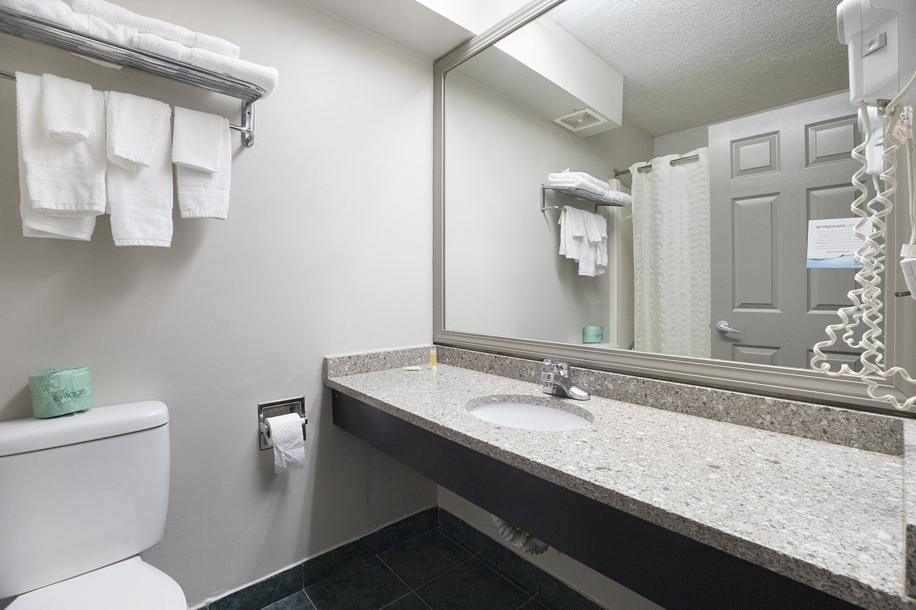 Guest room bath at the Days Inn & Suites by Wyndham Norton Shores/Muskegon in Norton Shores, Michigan