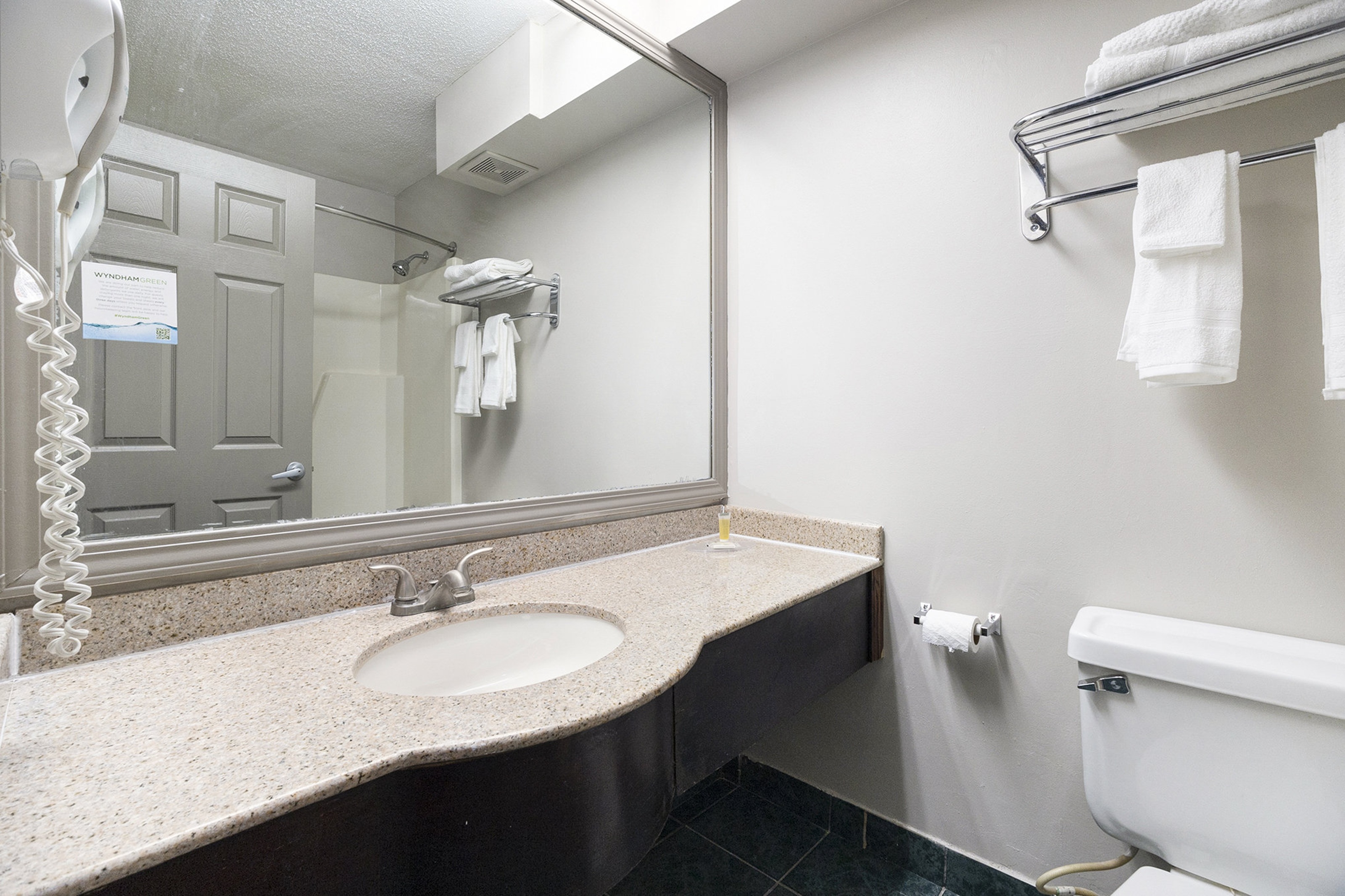 Guest room bath at the Days Inn & Suites by Wyndham Norton Shores/Muskegon in Norton Shores, Michigan