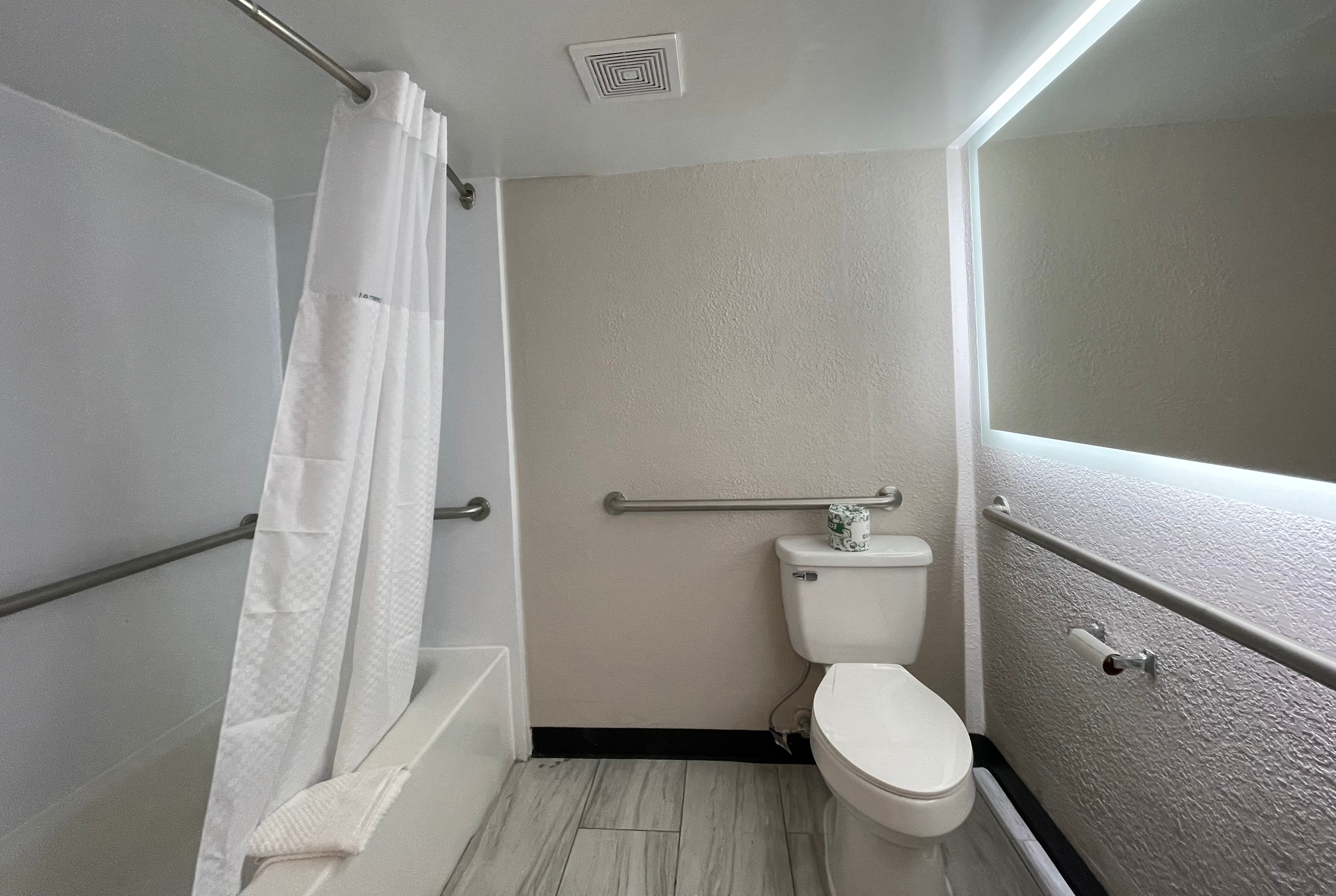 Guest room bath at the Days Inn & Suites by Wyndham Port Huron in Port Huron, Michigan