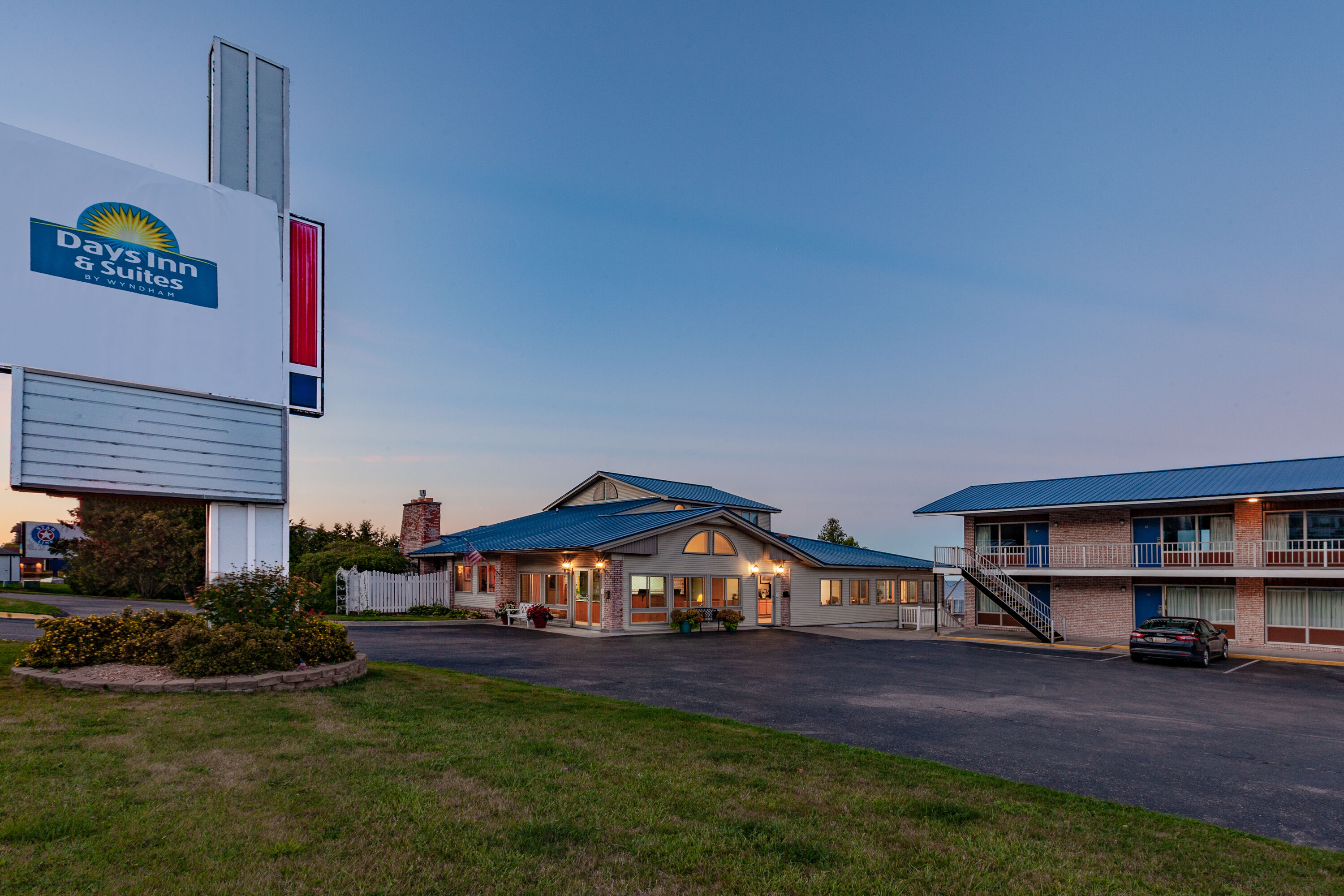 Exterior Dusk Image of Days Inn & Suites by Wyndham St. Ignace Lakefront hotel in St Ignace, Michigan