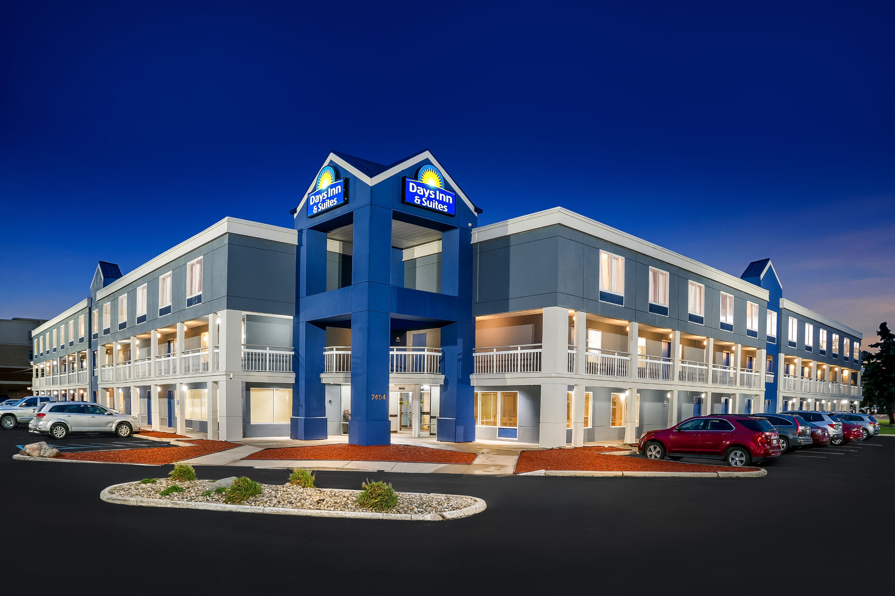 Exterior Night Image of Days Inn & Suites by Wyndham Warren hotel in Warren, Michigan