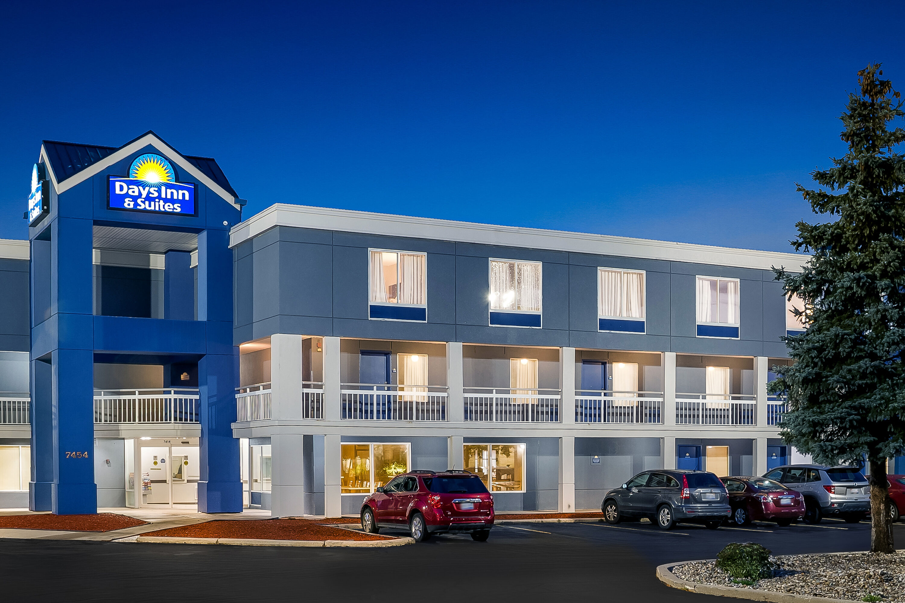 Exterior Night Image of Days Inn & Suites by Wyndham Warren hotel in Warren, Michigan