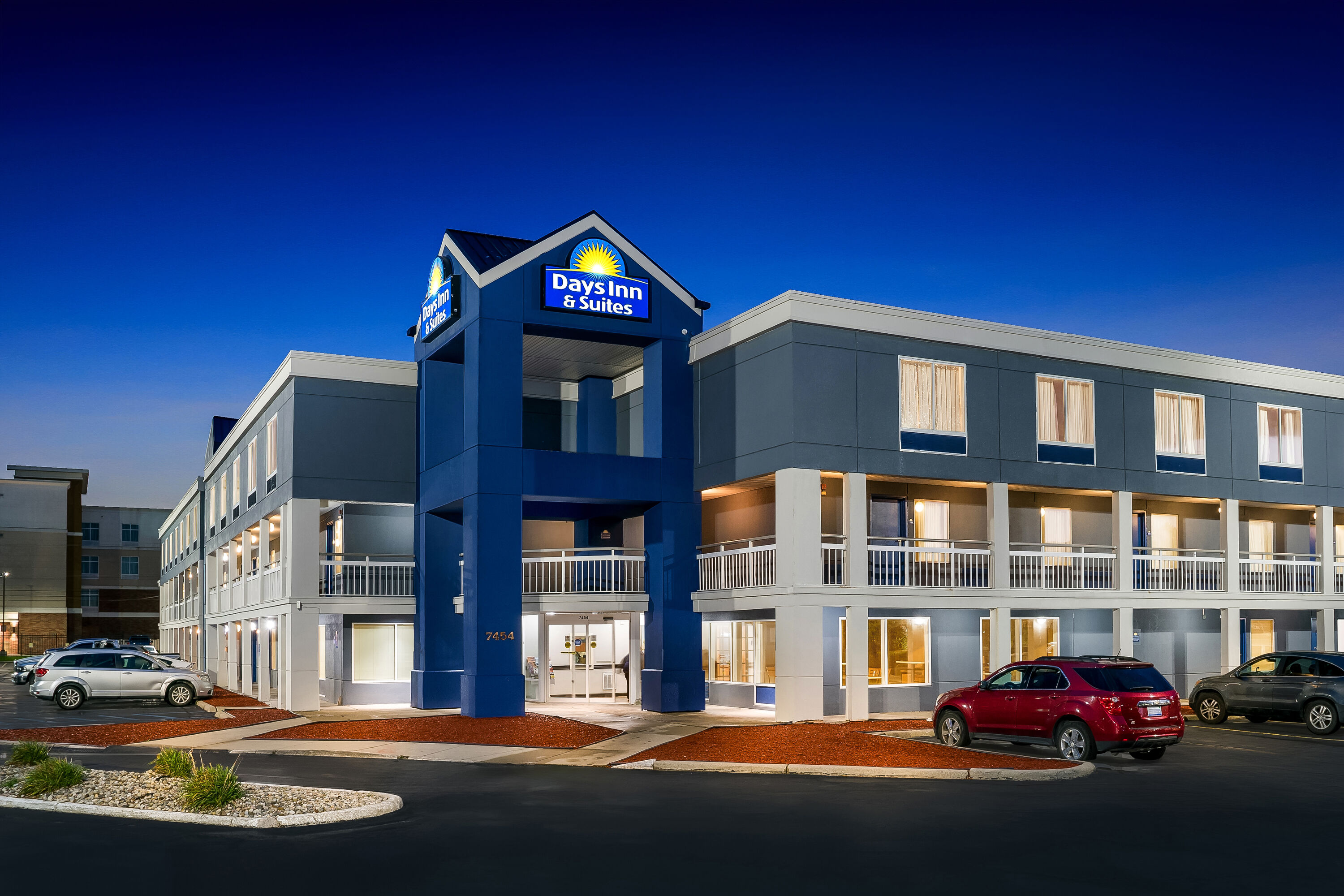 Exterior Night Image of Days Inn & Suites by Wyndham Warren hotel in Warren, Michigan