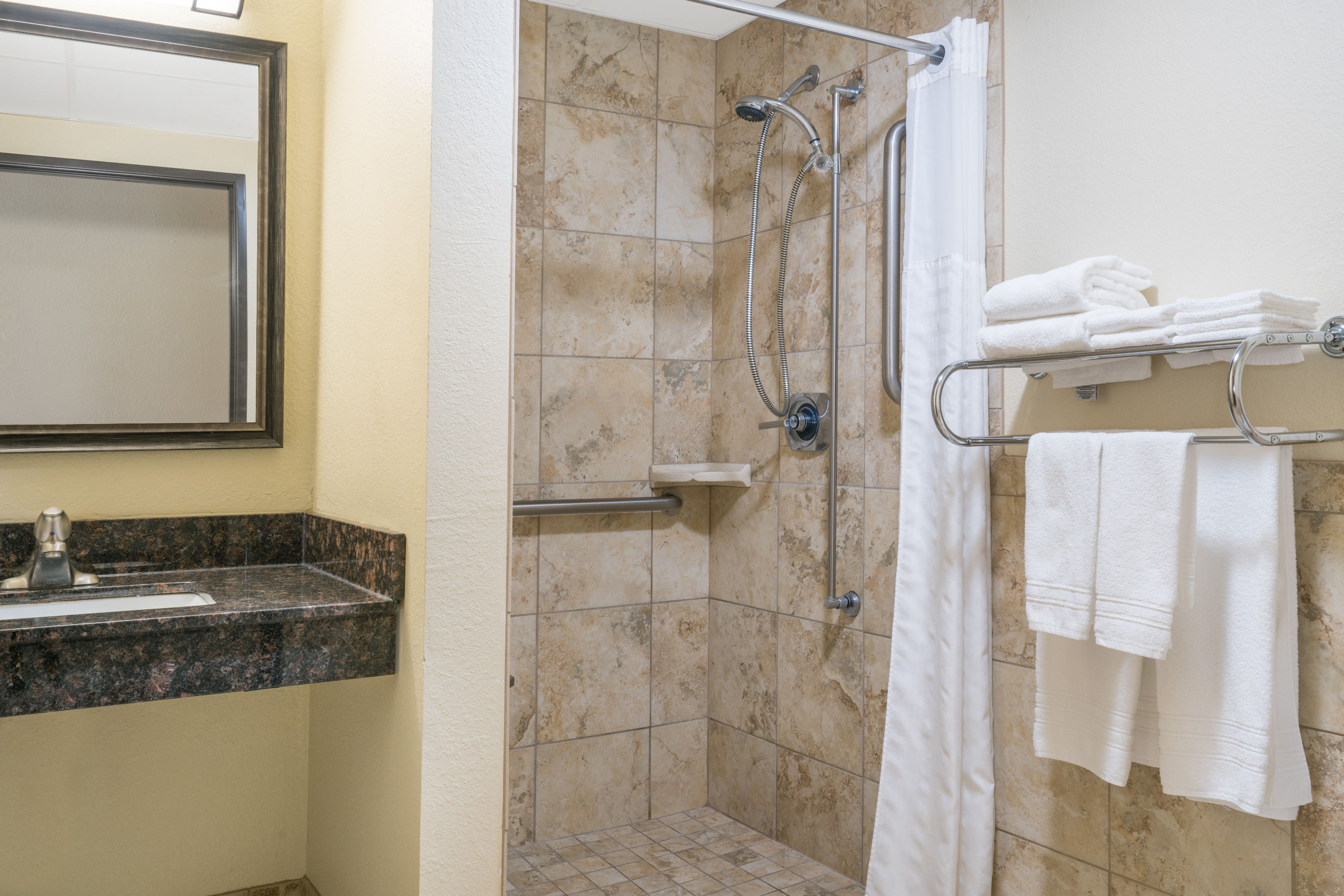 Guest room bath at the Days Inn & Suites by Wyndham Baxter Brainerd Area in Baxter, Minnesota