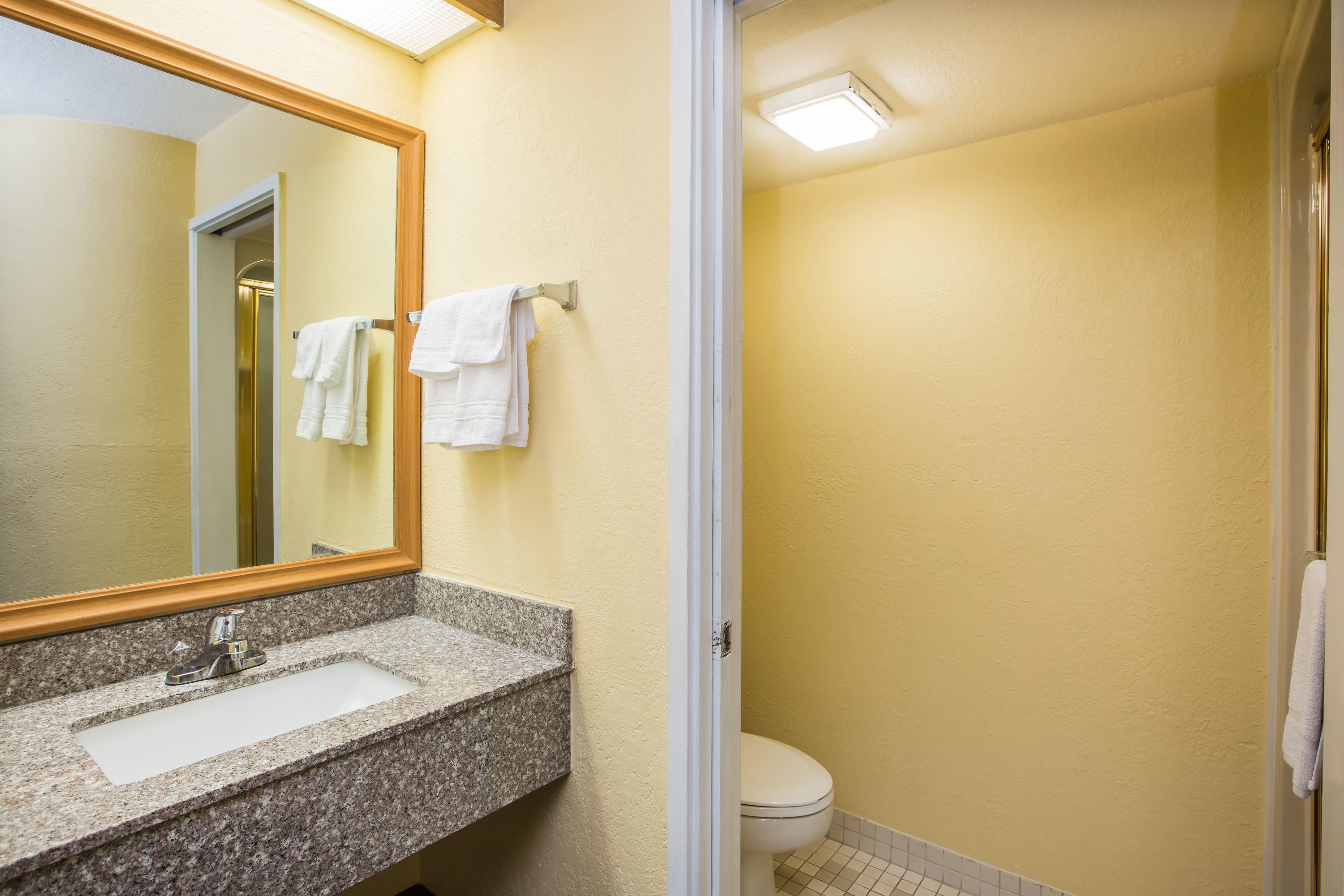 Guest room bath at the Days Inn by Wyndham Blue Springs in Blue Springs, Missouri