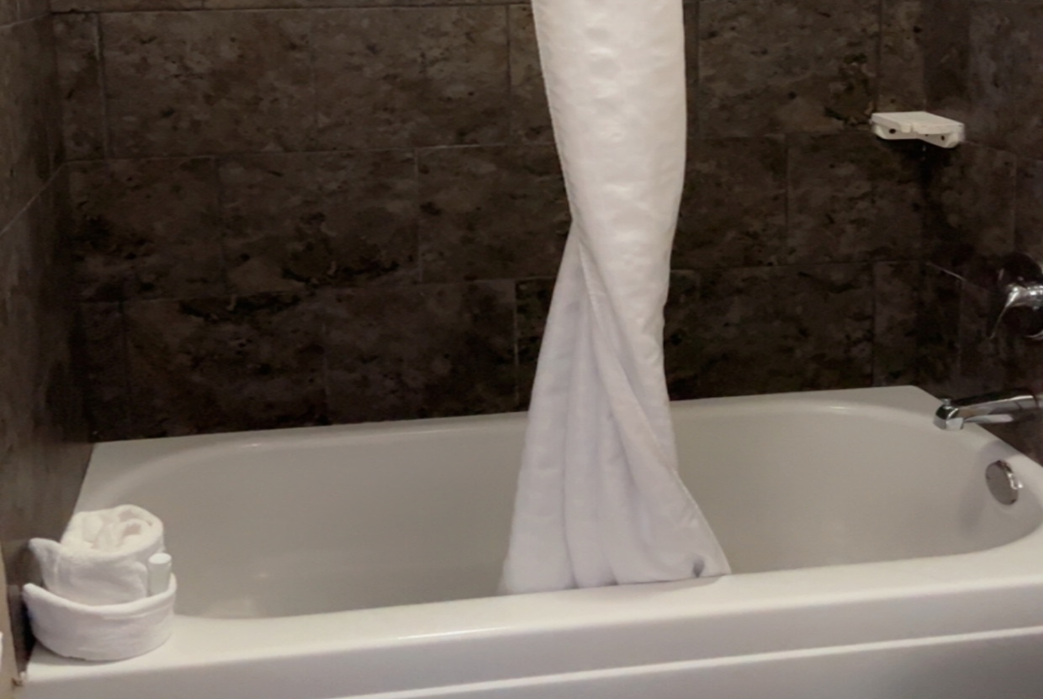 Guest room bath at the Days Inn & Suites by Wyndham Springfield on I-44 in Springfield, Missouri