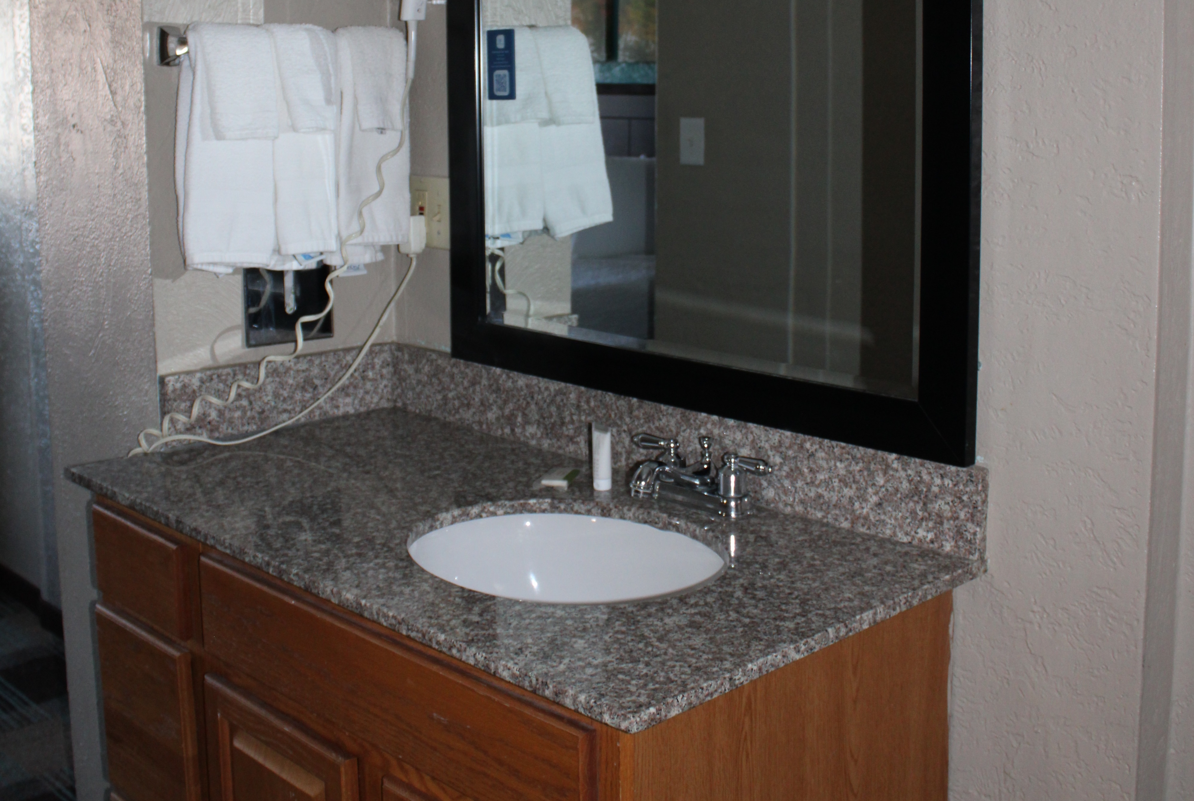 Guest room bath at the Days Inn & Suites by Wyndham Springfield on I-44 in Springfield, Missouri