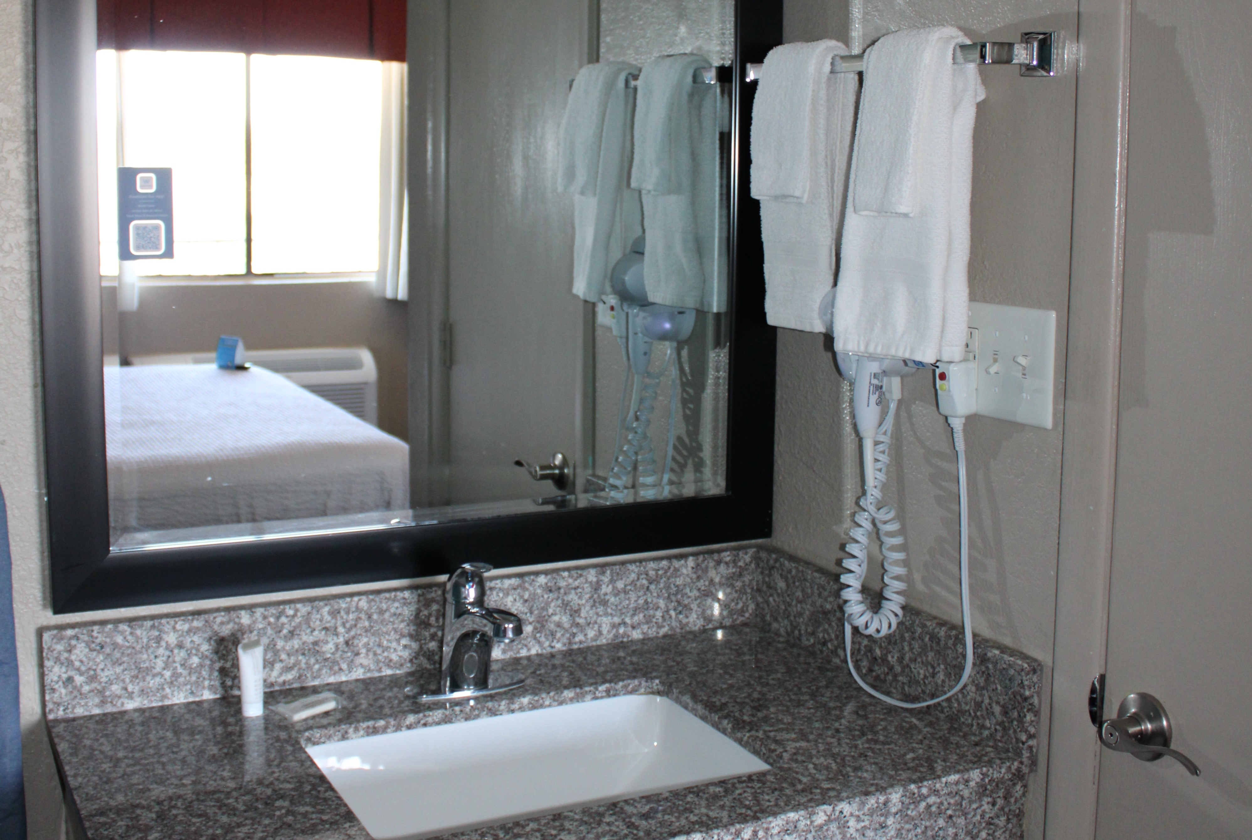 Guest room bath at the Days Inn & Suites by Wyndham Springfield on I-44 in Springfield, Missouri