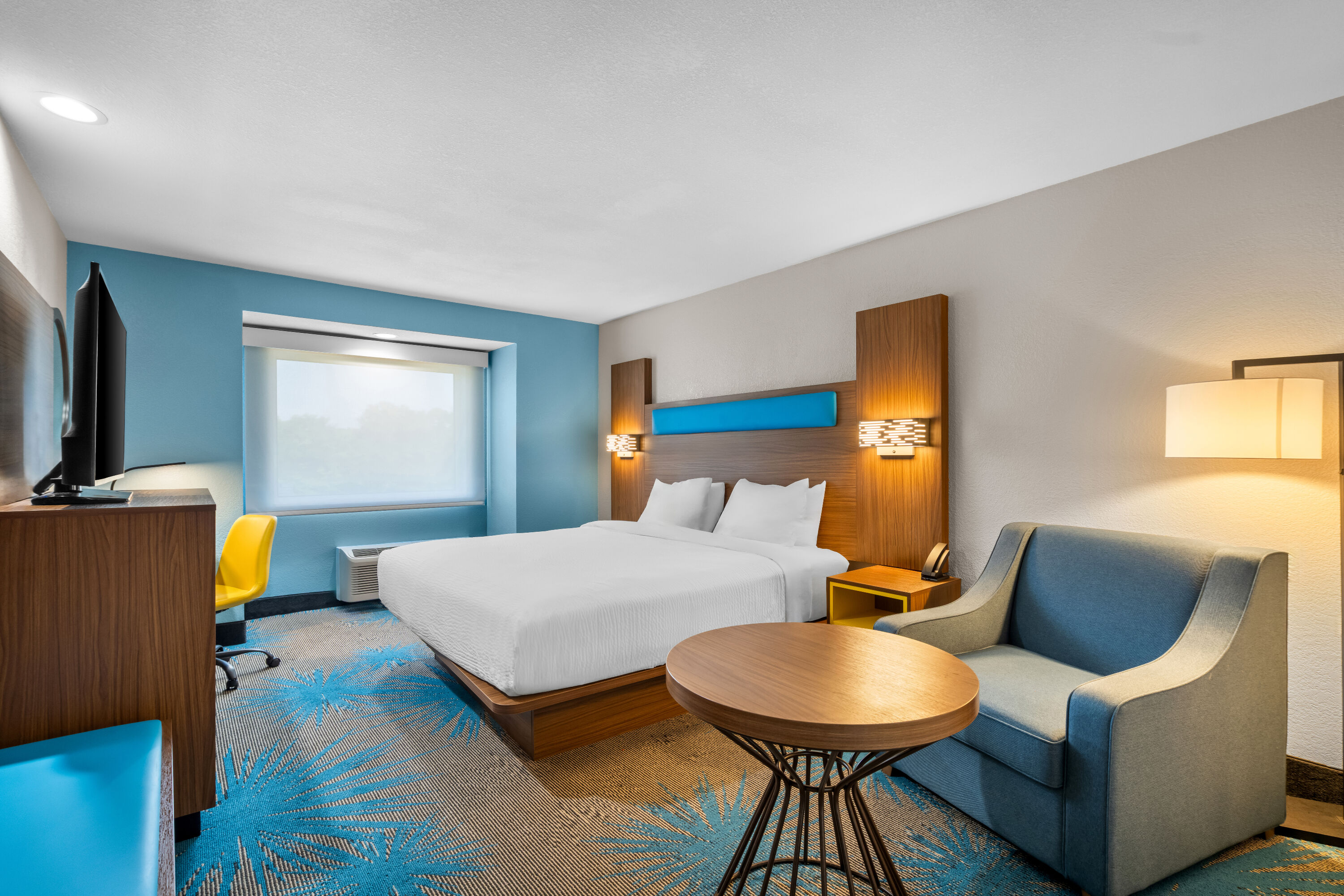 King bed guest room at the Days Inn & Suites by Wyndham Brandon Amphitheater in Brandon, Mississippi