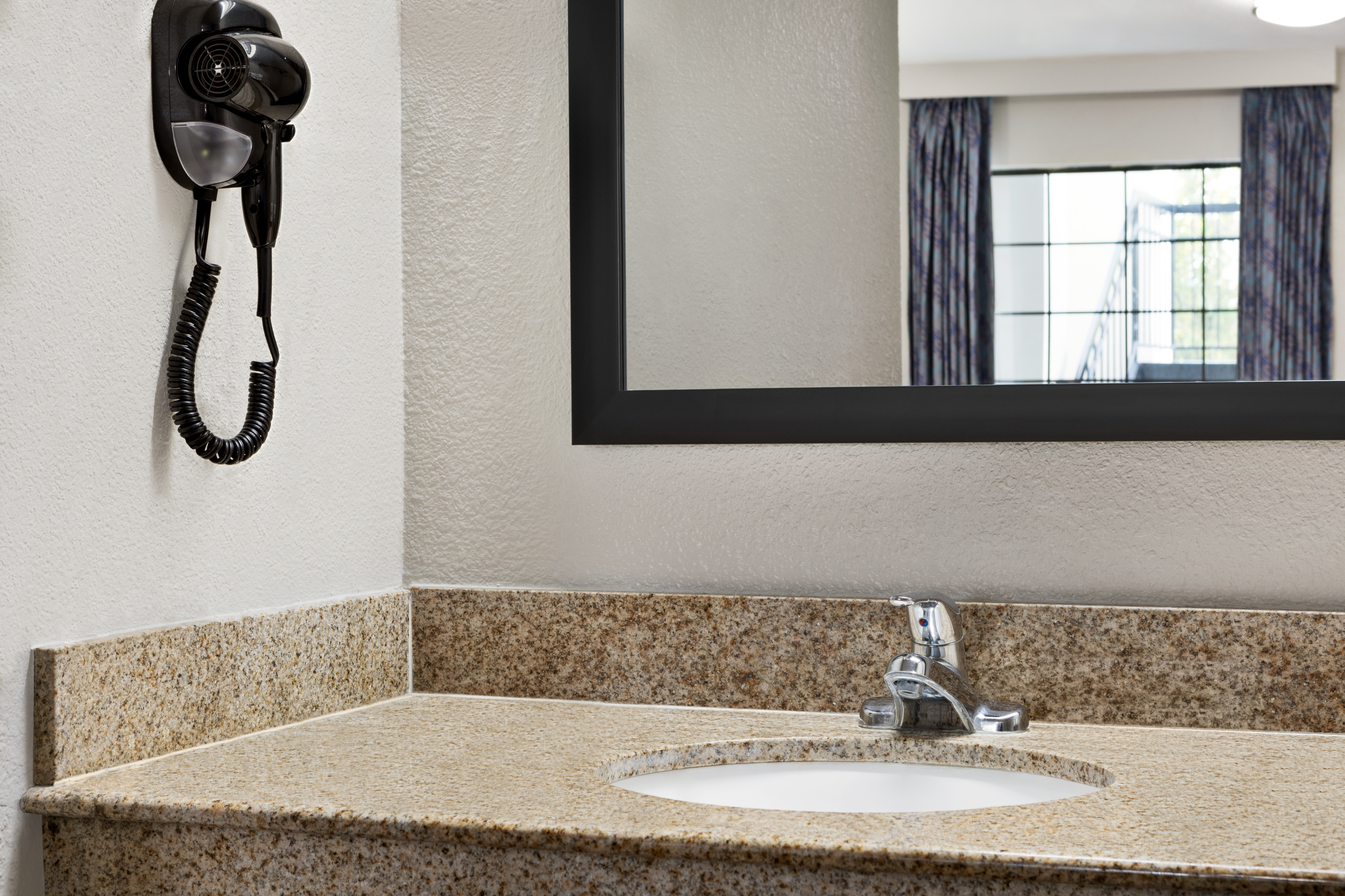 Guest room bath at the Days Inn by Wyndham Fulton in Fulton, Mississippi