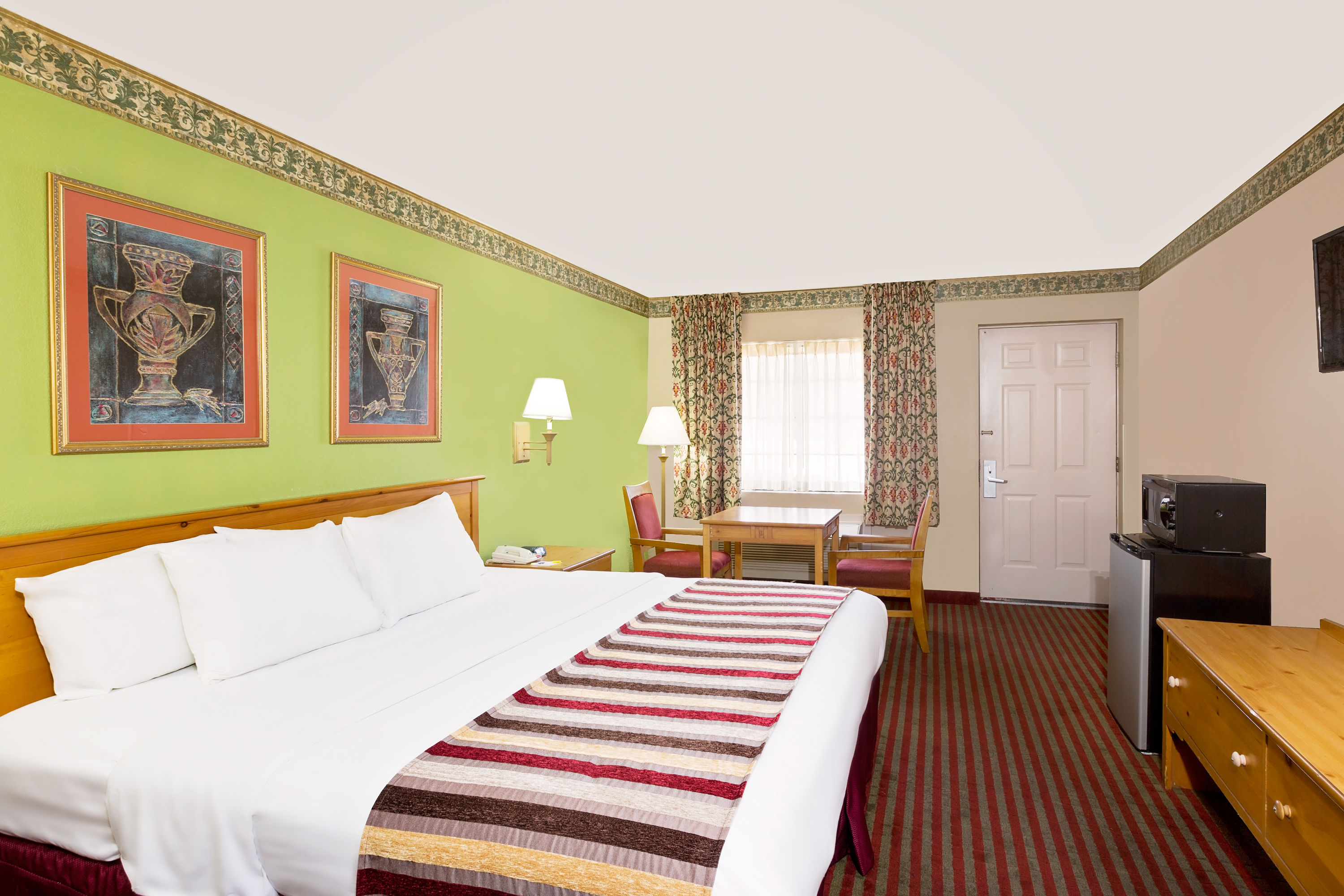 Guest room at the Days Inn & Suites by Wyndham Starkville in Starkville, Mississippi