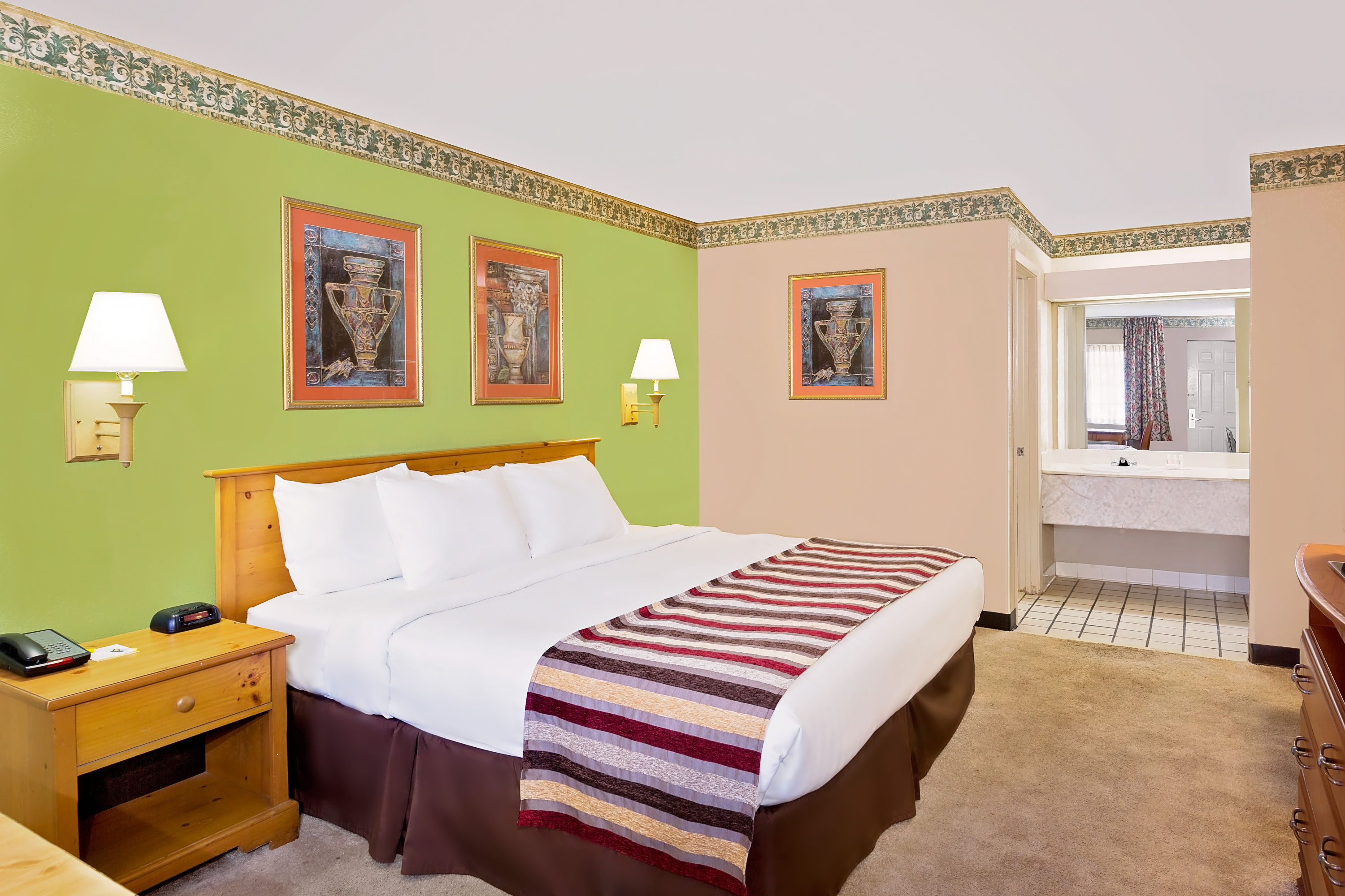 Guest room at the Days Inn & Suites by Wyndham Starkville in Starkville, Mississippi