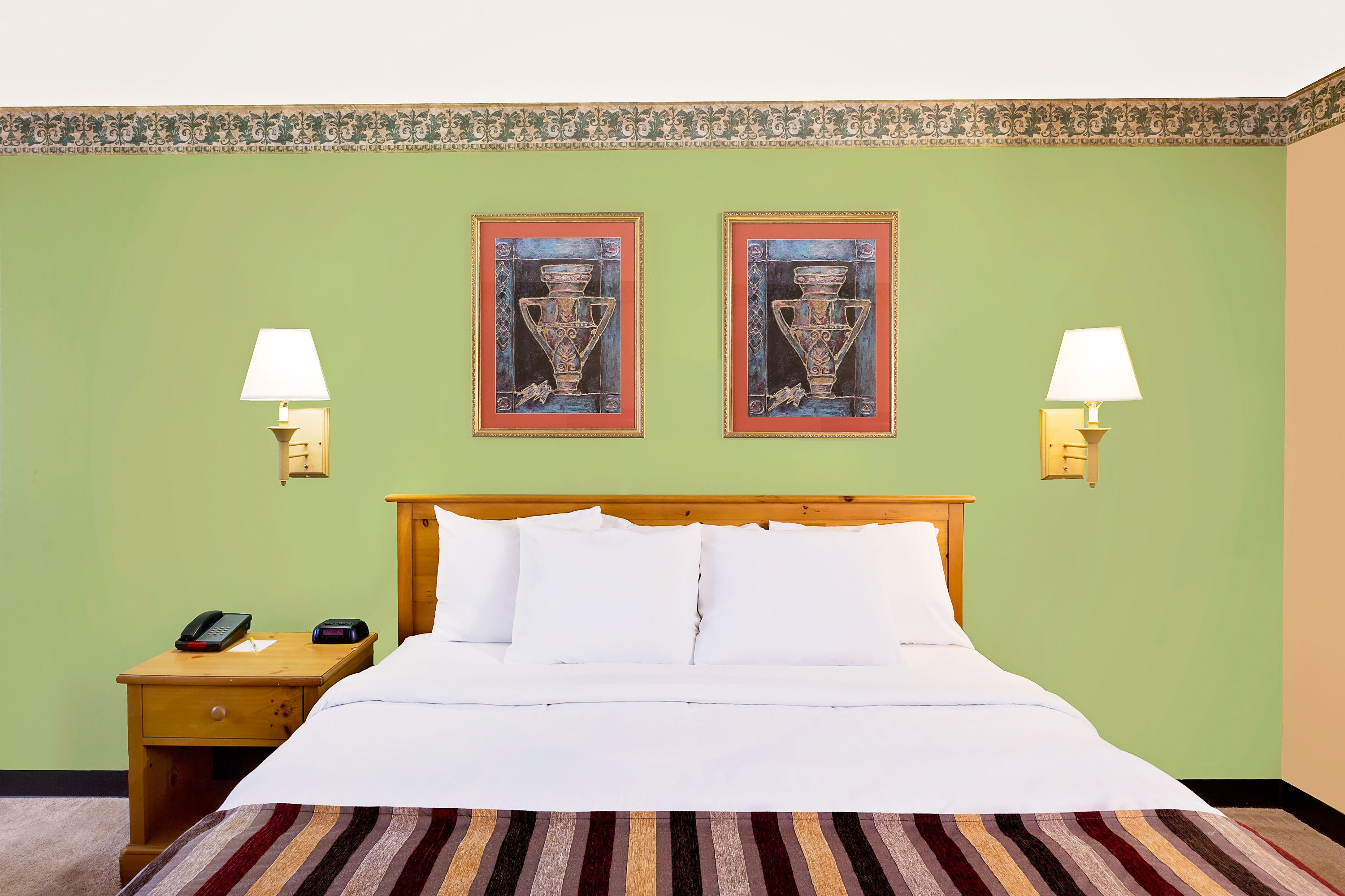 Guest room at the Days Inn & Suites by Wyndham Starkville in Starkville, Mississippi