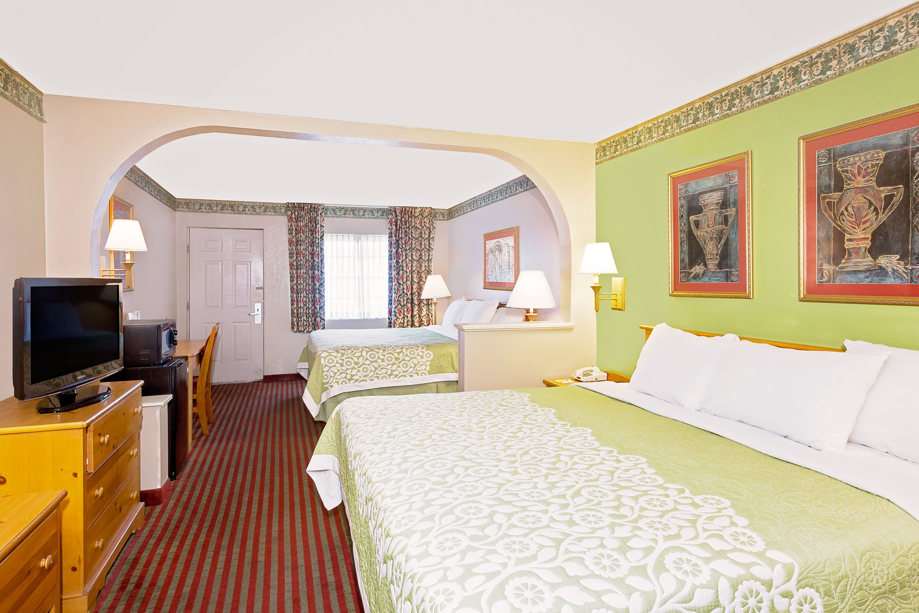 Guest room at the Days Inn & Suites by Wyndham Starkville in Starkville, Mississippi