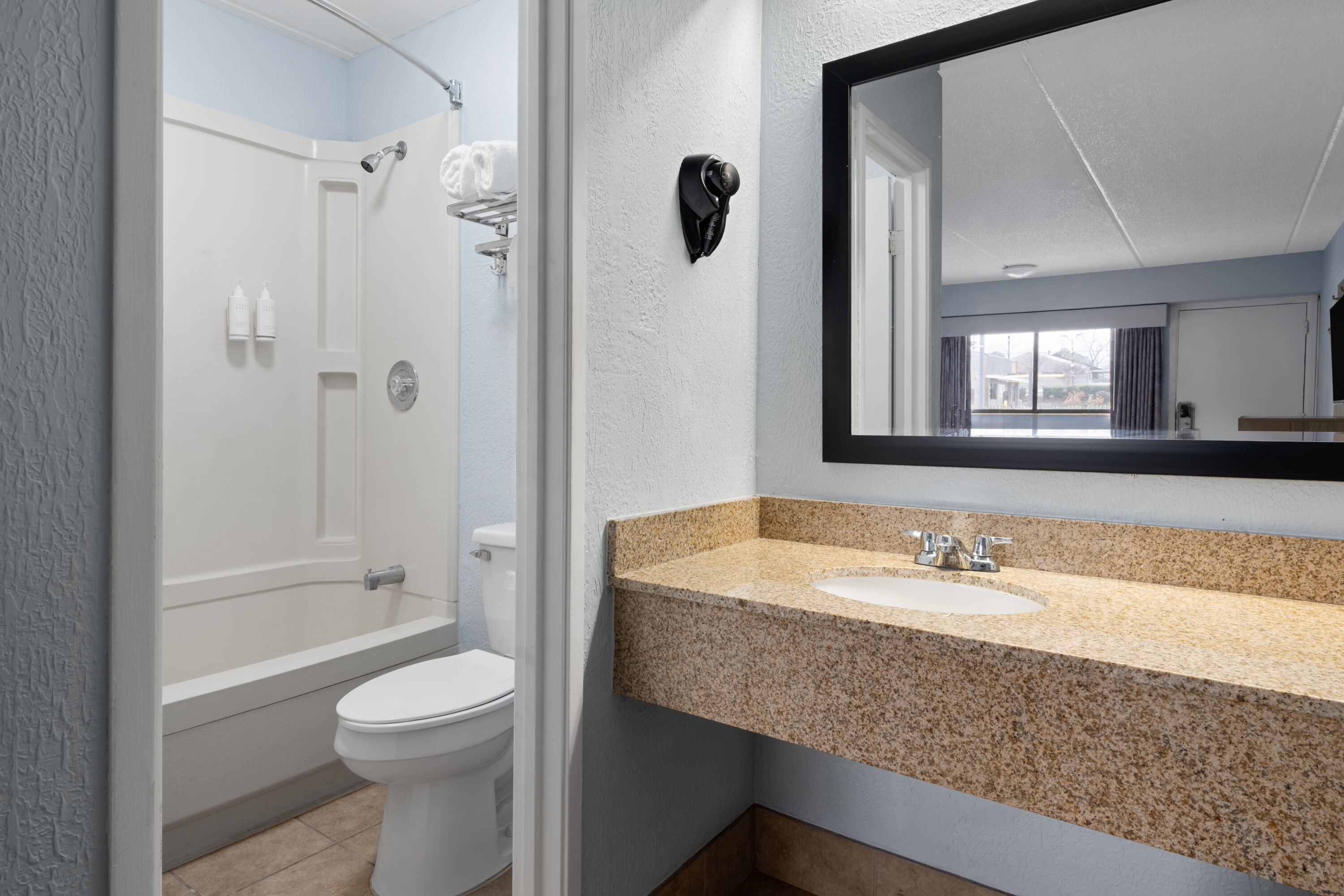 Guest room bath at the Days Inn by Wyndham Charlotte University in Charlotte, North Carolina