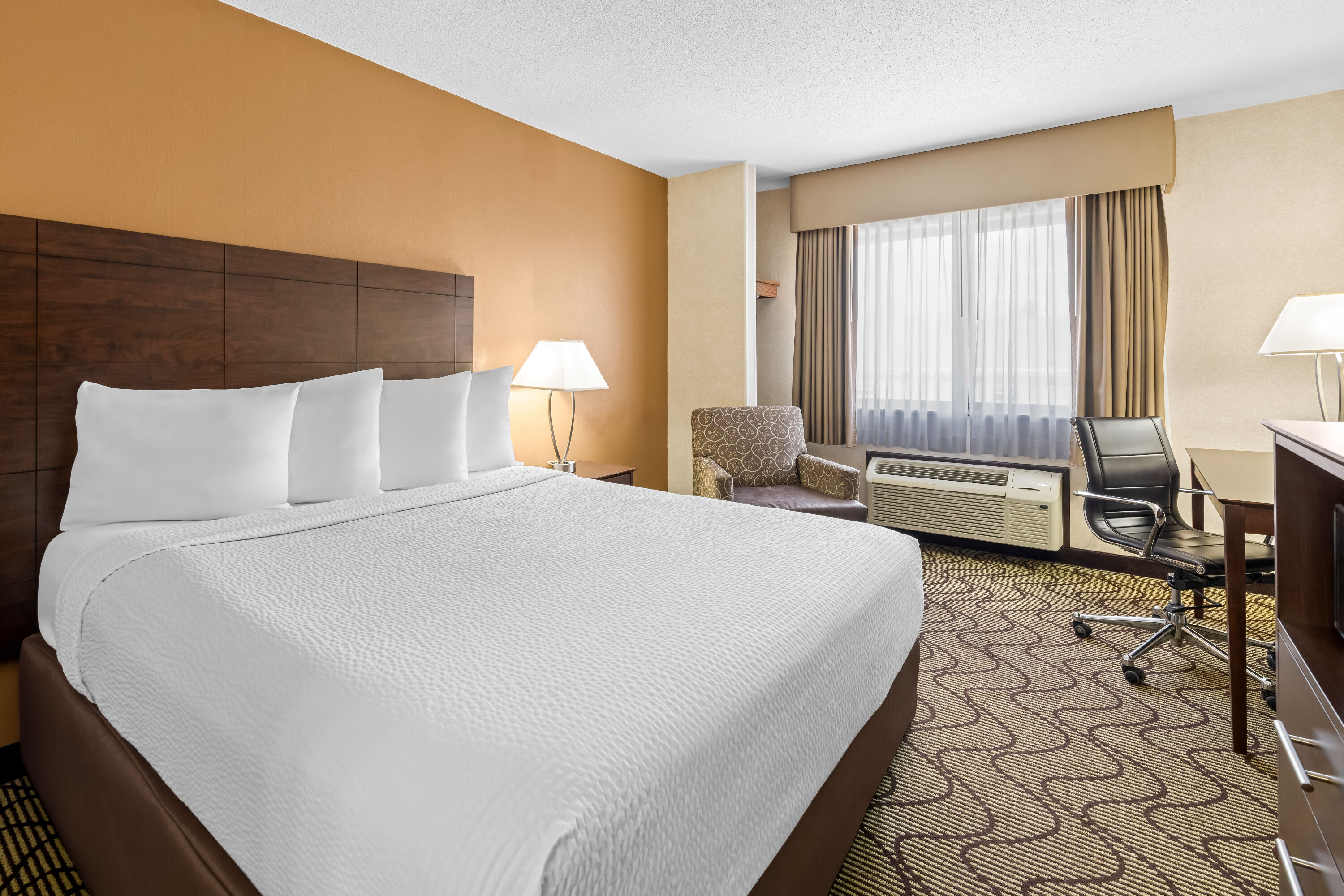 Queen bed guest room at the Days Inn by Wyndham Grand Forks Columbia Mall in Grand Forks, North Dakota