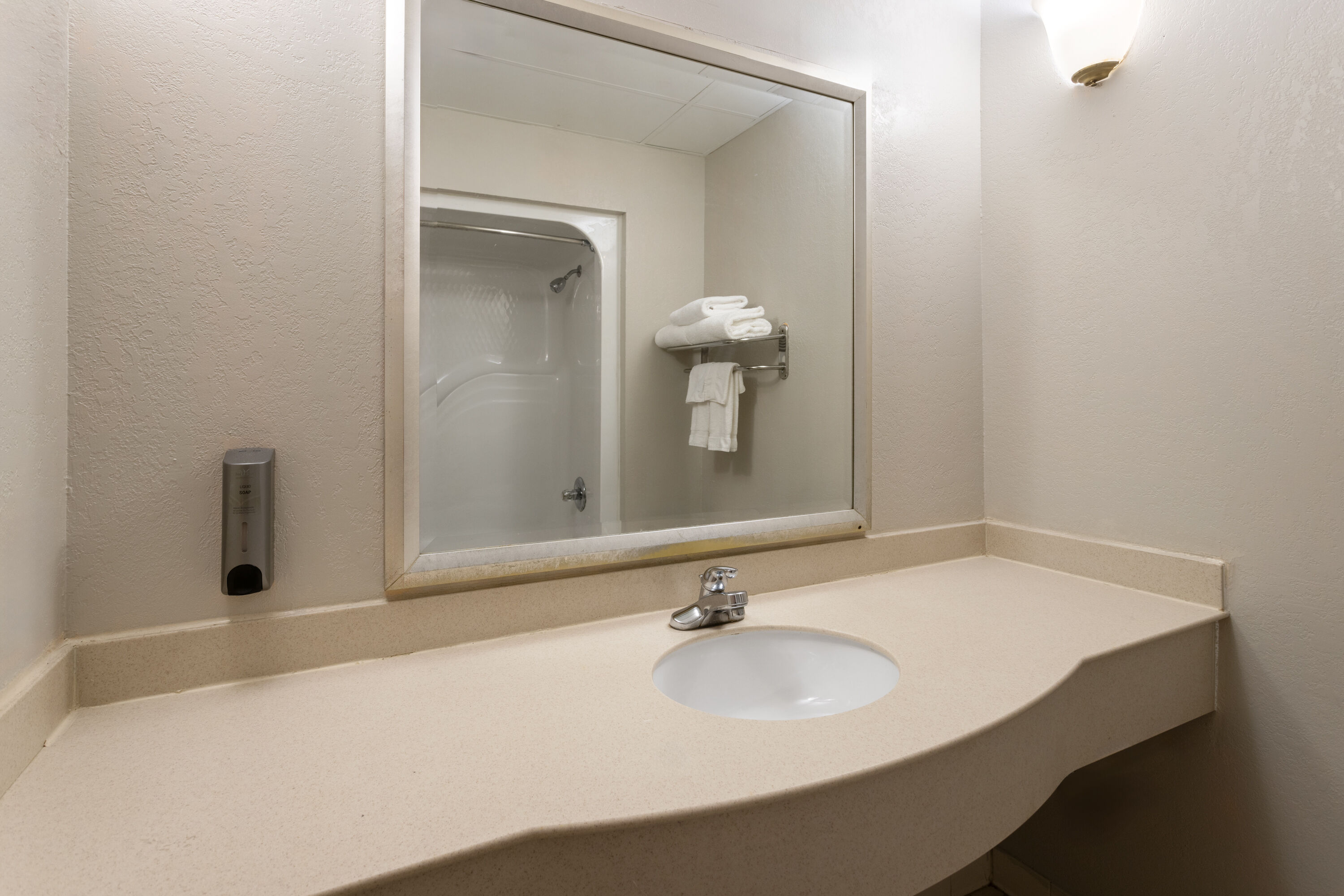 Guest room bath at the Days Inn & Suites by Wyndham Albany in Albany, New York