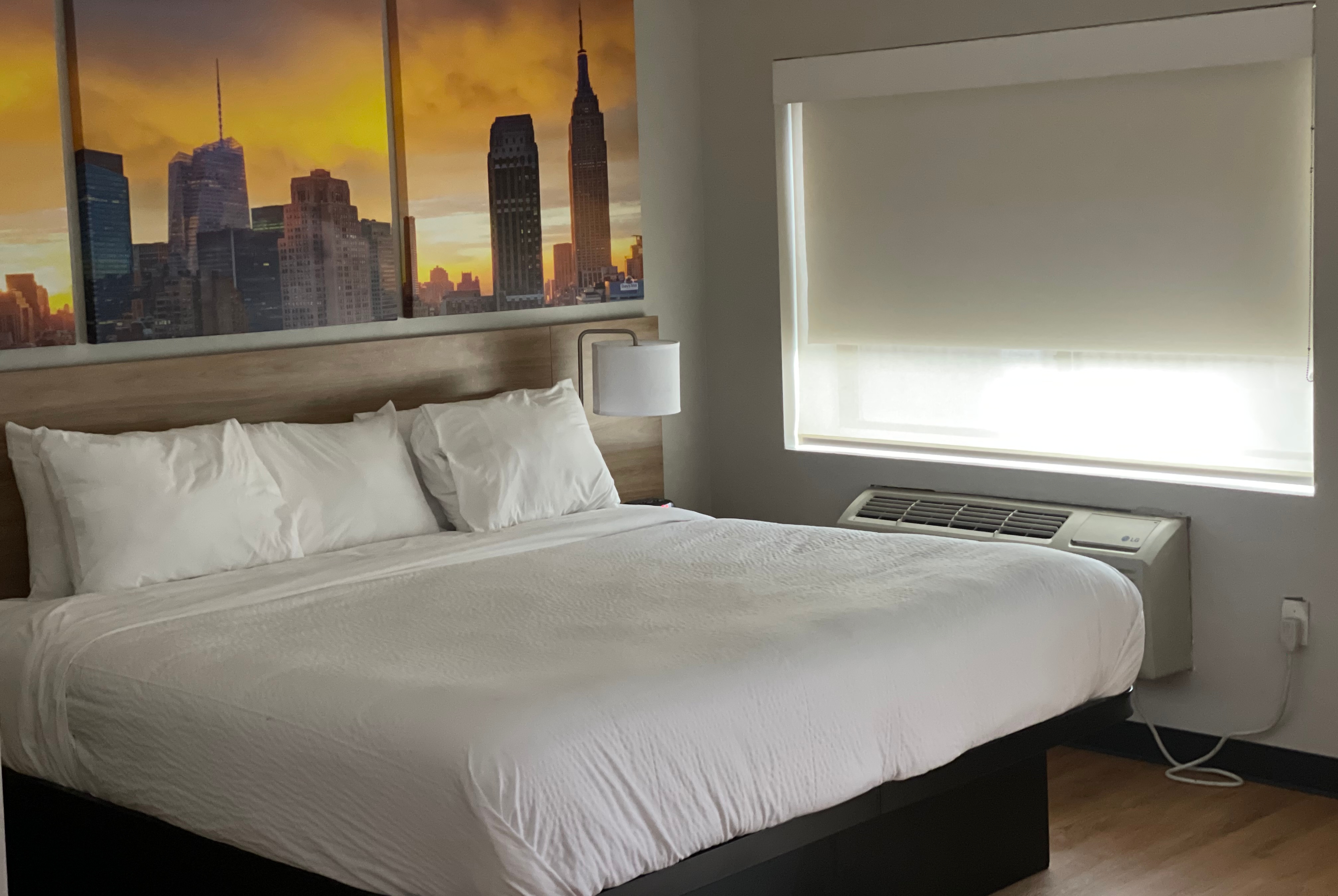 Guest room at the Days Inn & Suites by Wyndham Jamaica JFK Airport in Jamaica, New York