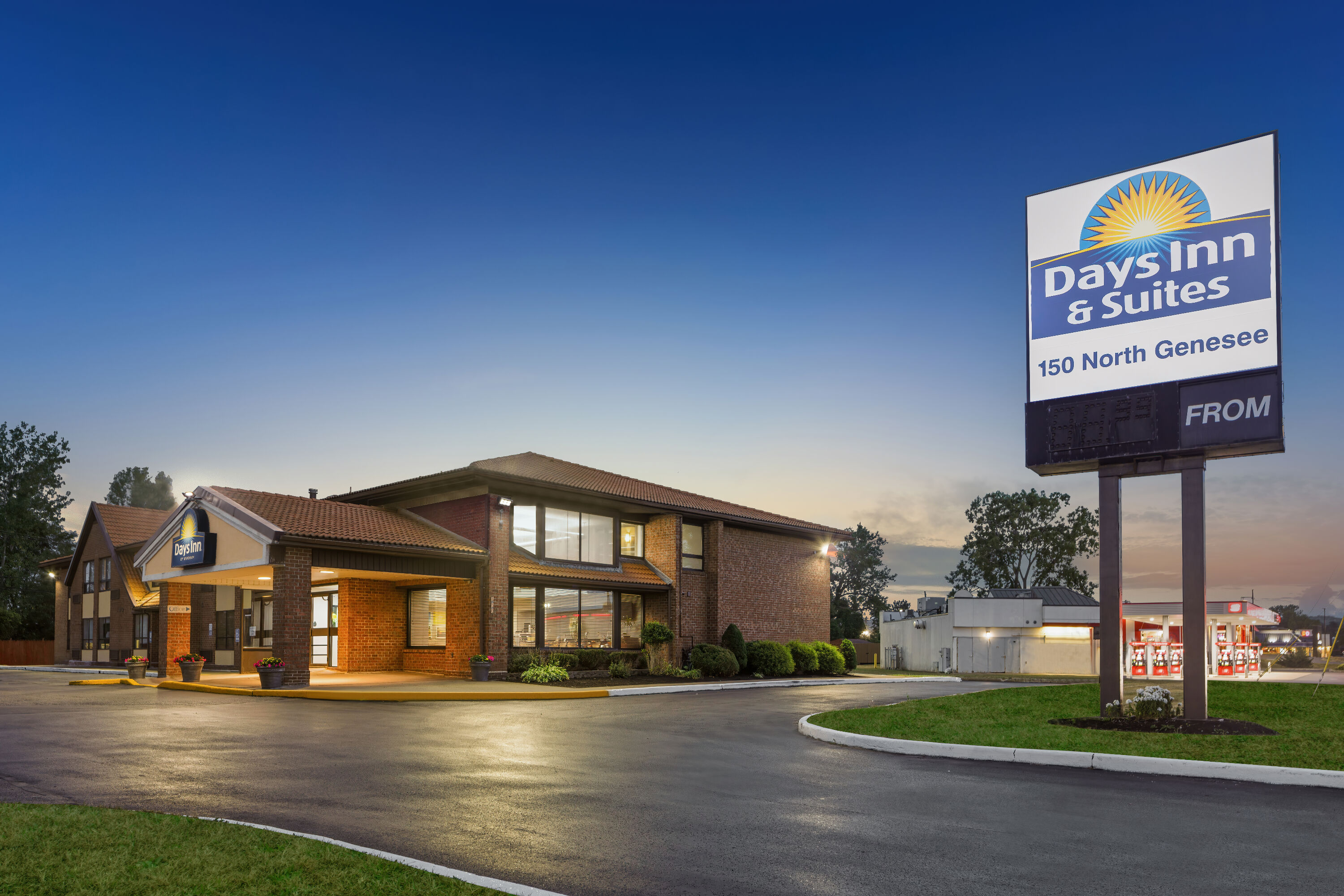 Exterior Dusk Image of Days Inn by Wyndham Utica hotel in Utica, New York