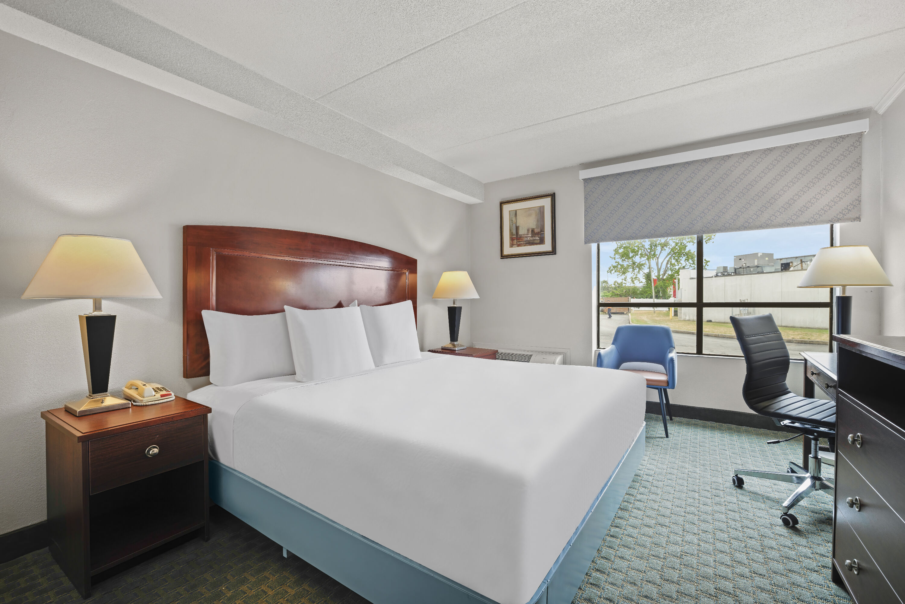 King bed guest room at the Days Inn by Wyndham Utica in Utica, New York