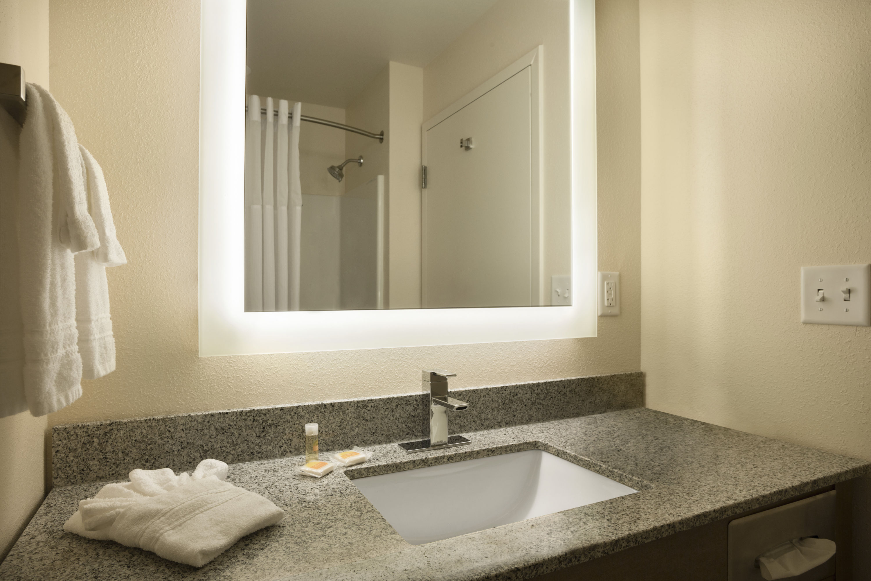 Guest room bath at the Days Inn & Suites by Wyndham Caldwell in Caldwell, Ohio