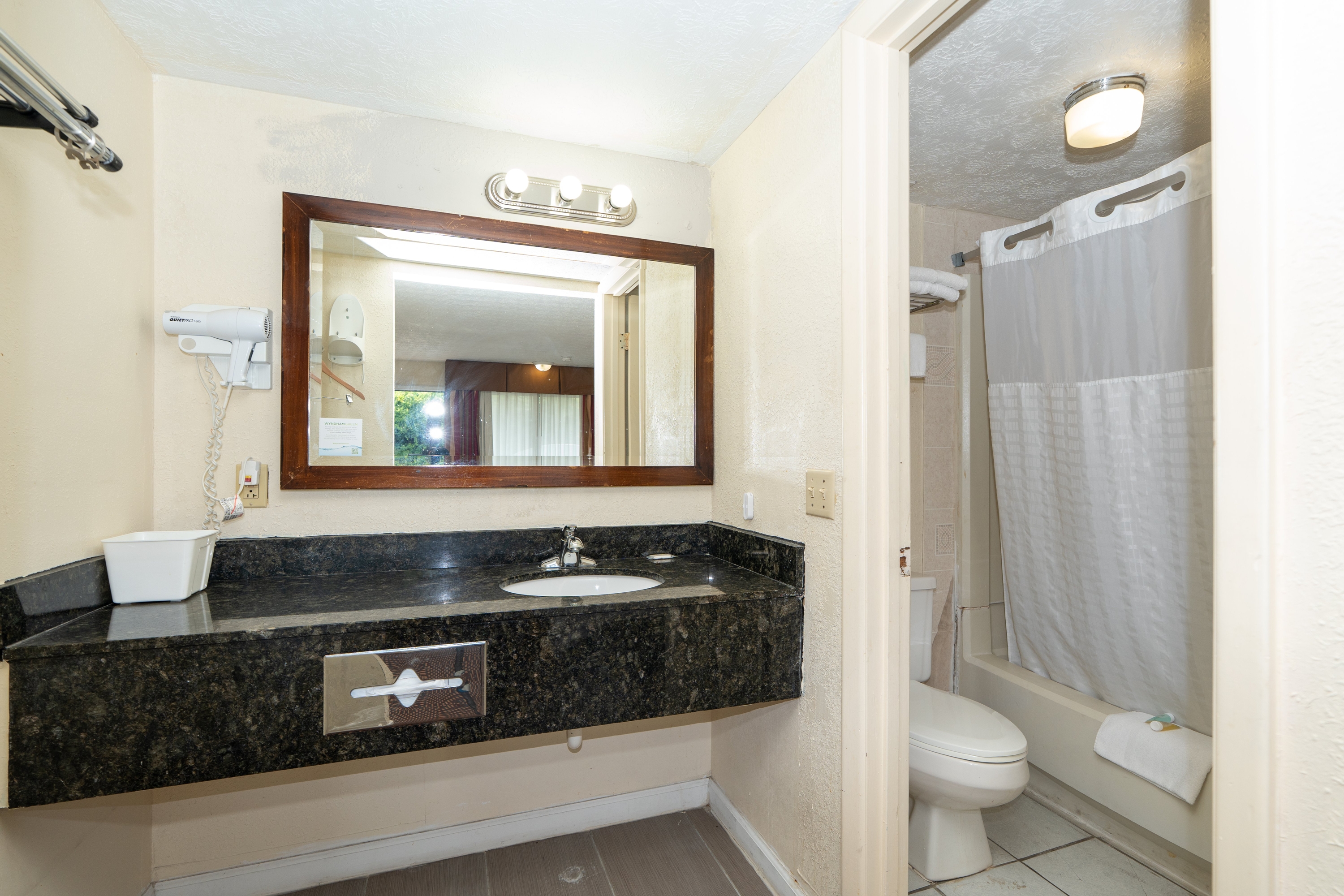 Guest room bath at the Days Inn & Suites by Wyndham Dayton North in Dayton, Ohio