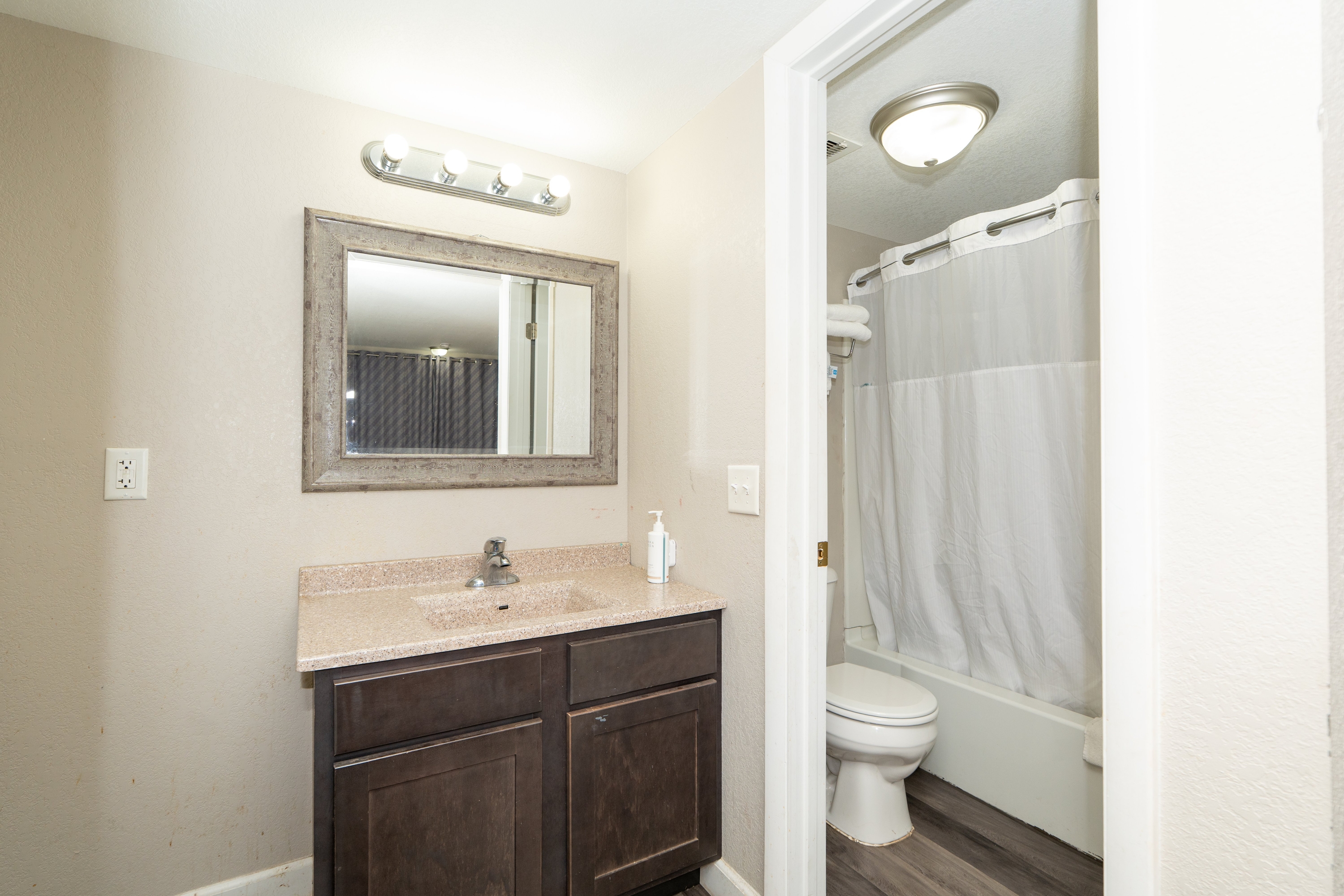 Guest room bath at the Days Inn & Suites by Wyndham Dayton North in Dayton, Ohio