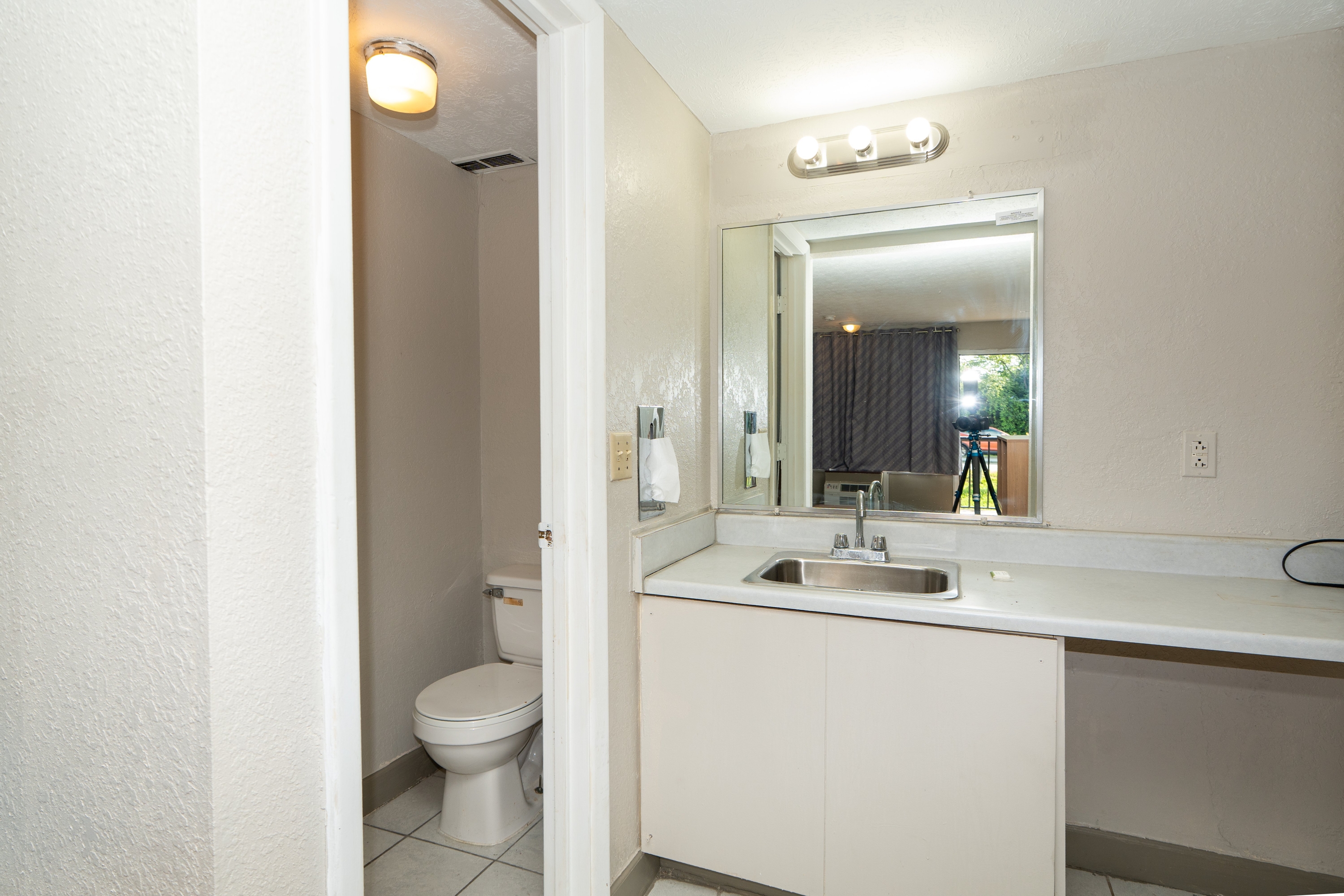 Guest room bath at the Days Inn & Suites by Wyndham Dayton North in Dayton, Ohio