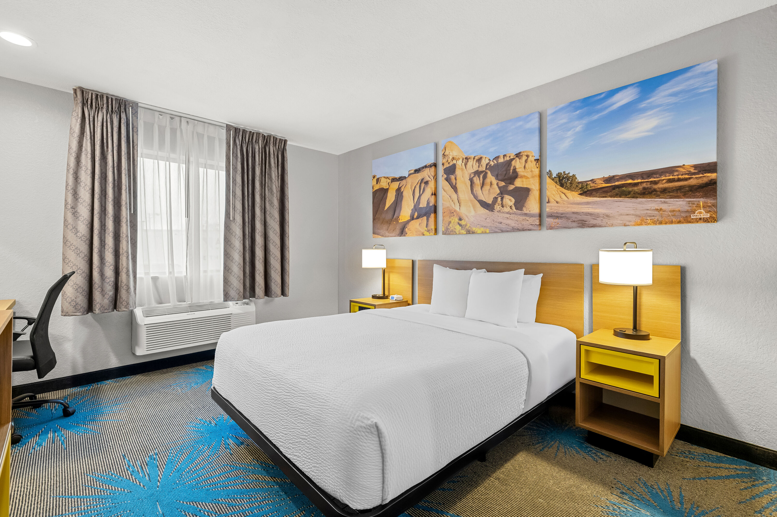 Queen bed guest room at the Days Inn by Wyndham Wall in Wall, South Dakota