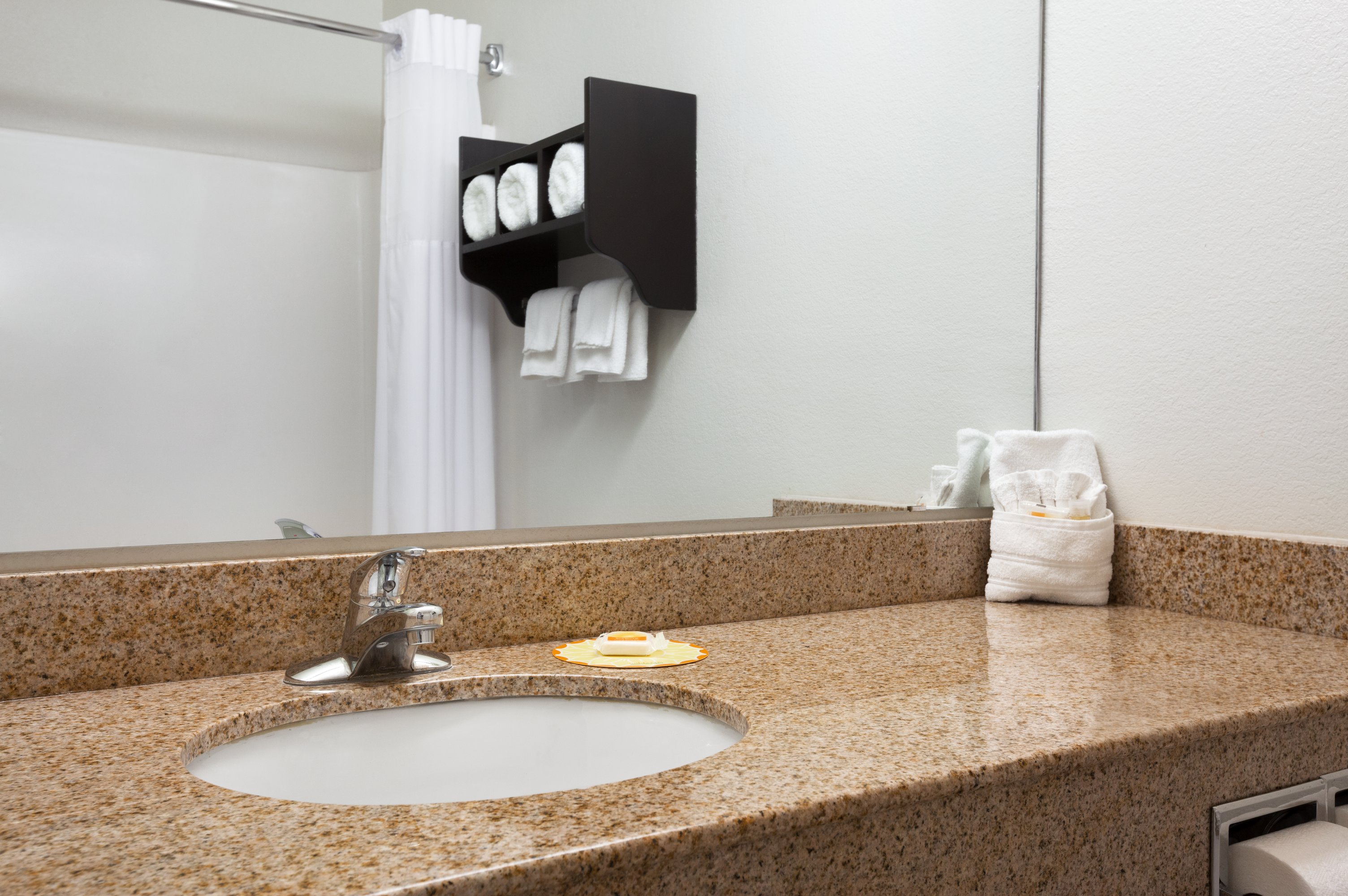 Guest room bath at the Days Inn & Suites by Wyndham Conroe North in Conroe, Texas