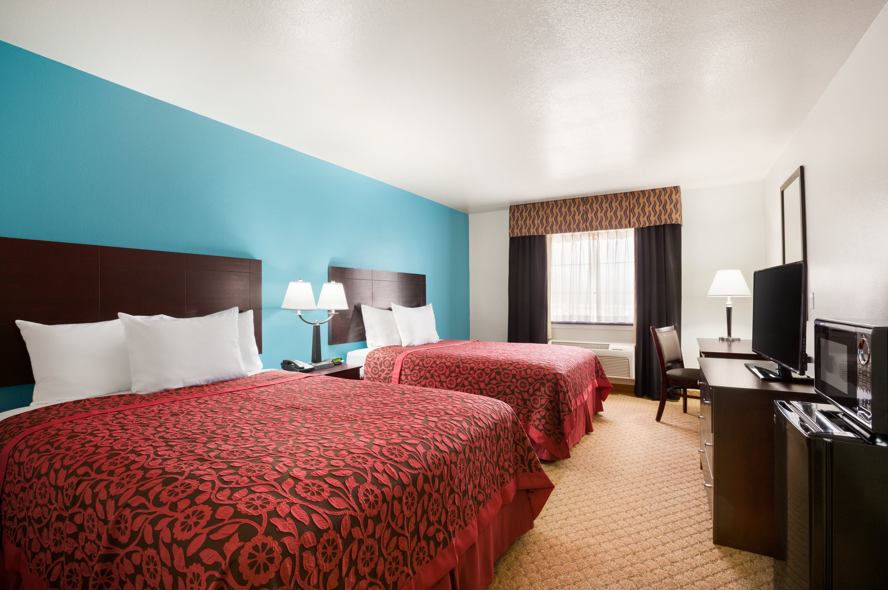 Guest room at the Days Inn & Suites by Wyndham Conroe North in Conroe, Texas