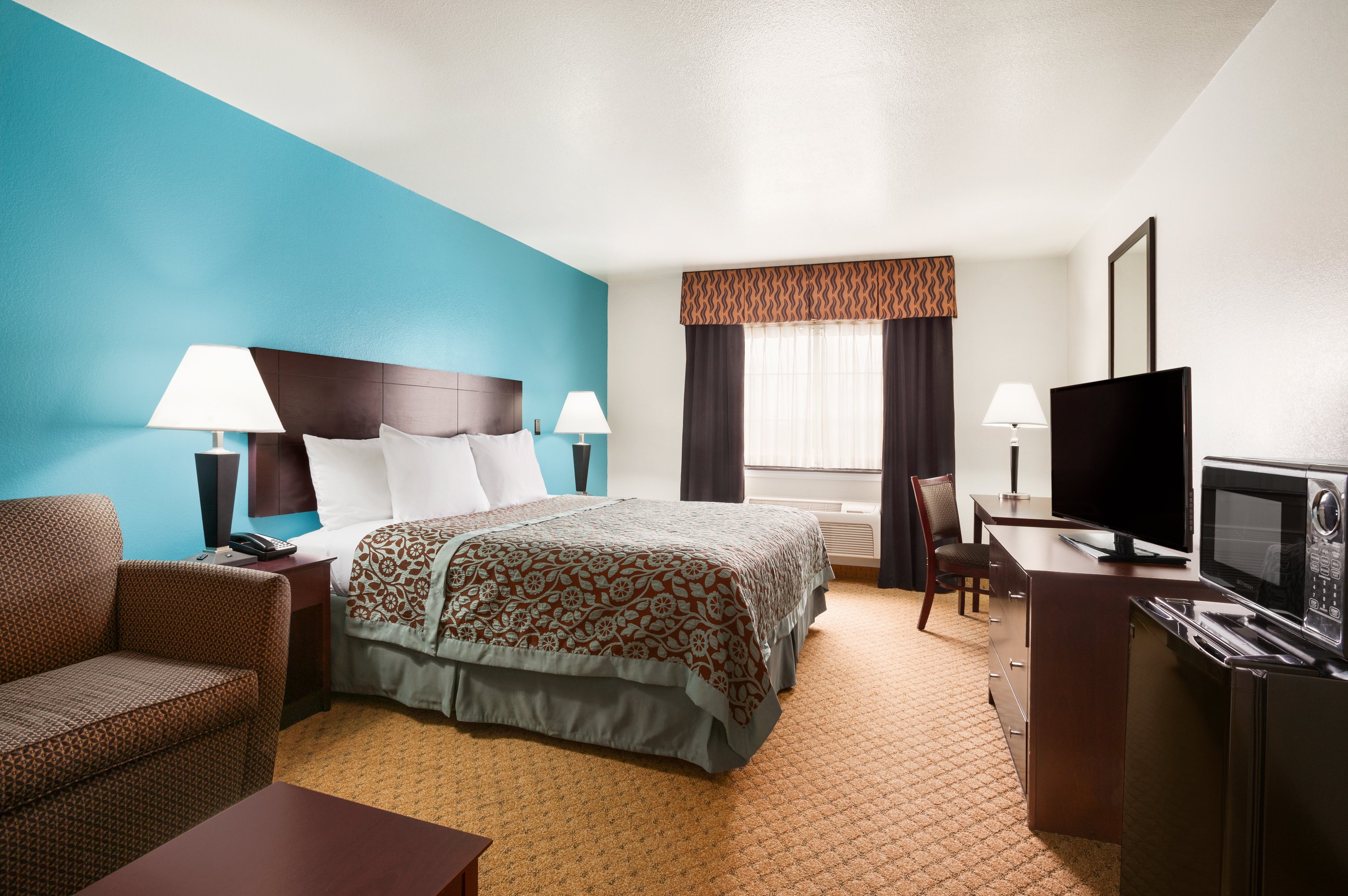 Guest room at the Days Inn & Suites by Wyndham Conroe North in Conroe, Texas