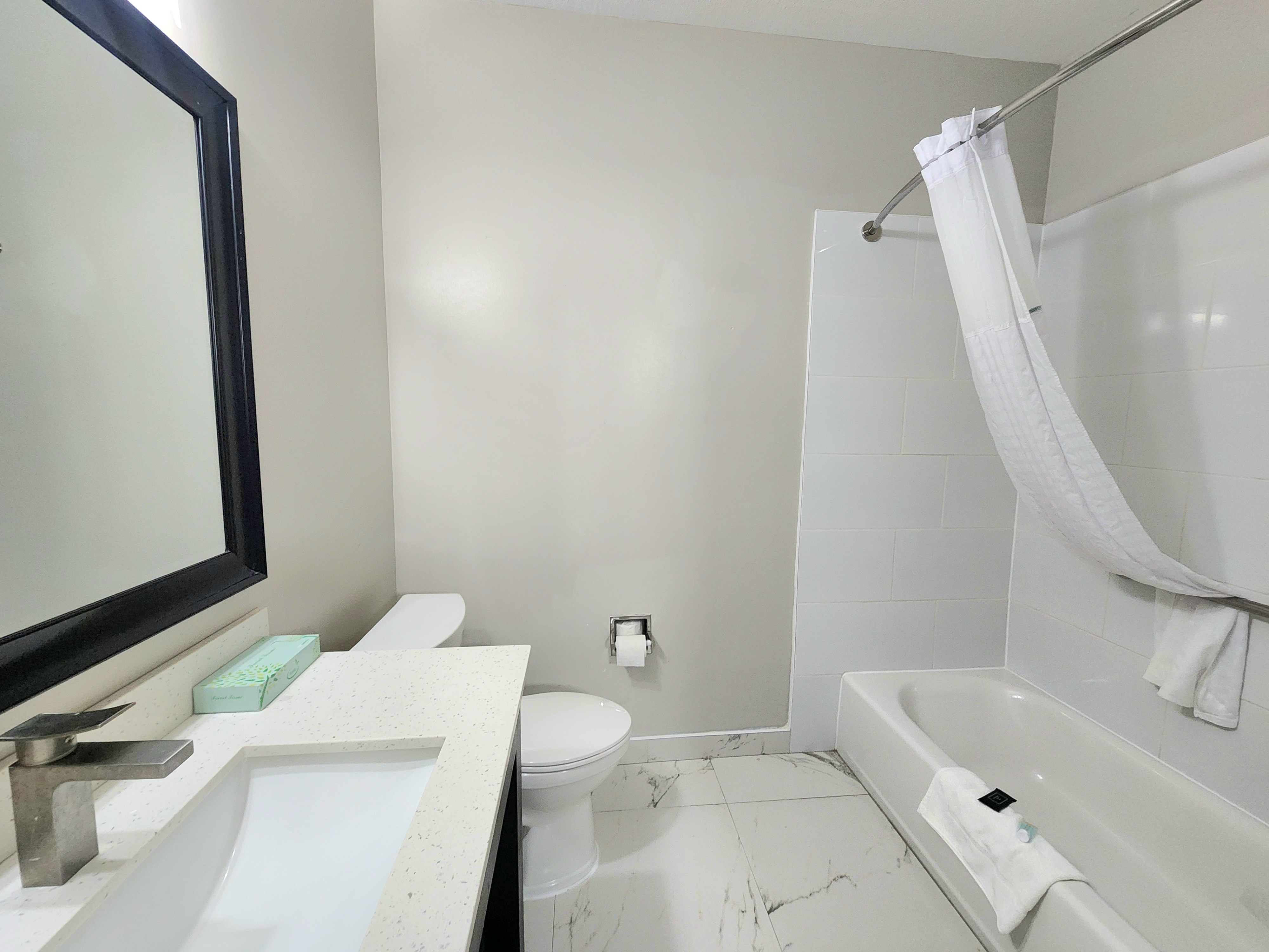 Guest room bath at the Days Inn & Suites by Wyndham Corpus Christi Central in Corpus Christi, Texas
