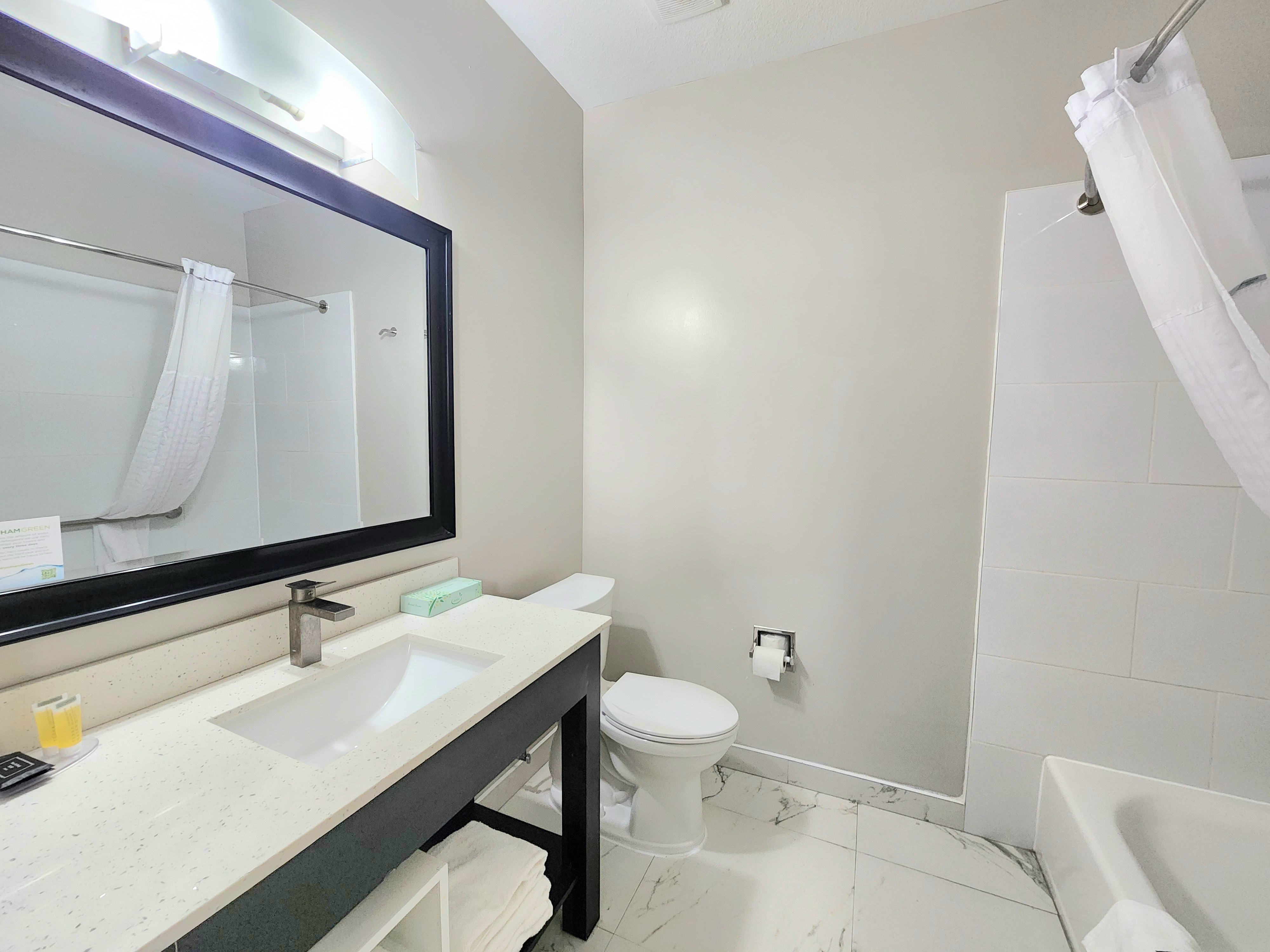 Guest room bath at the Days Inn & Suites by Wyndham Corpus Christi Central in Corpus Christi, Texas