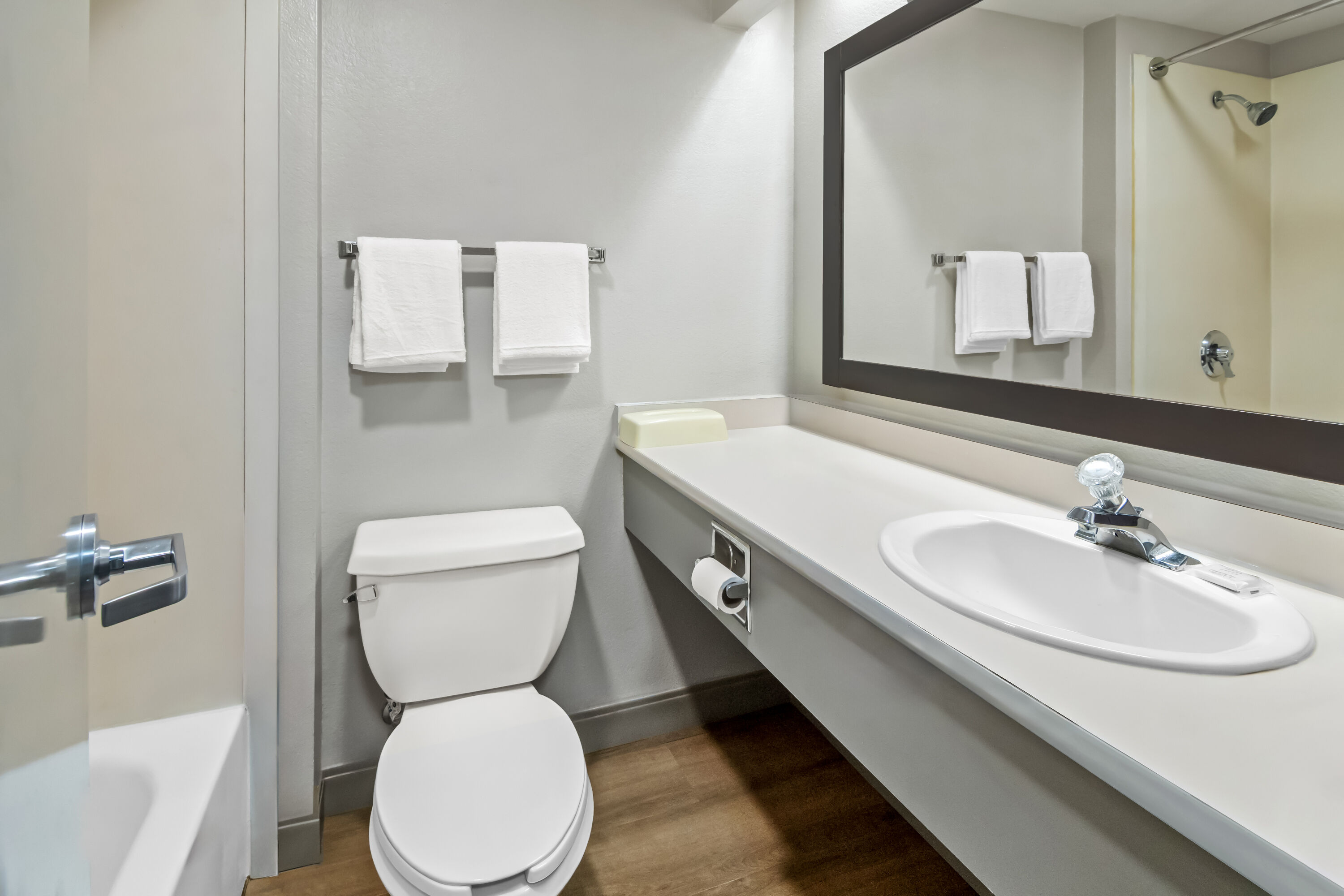 Guest room bath at the Days Inn & Suites by Wyndham DeSoto in DeSoto, Texas