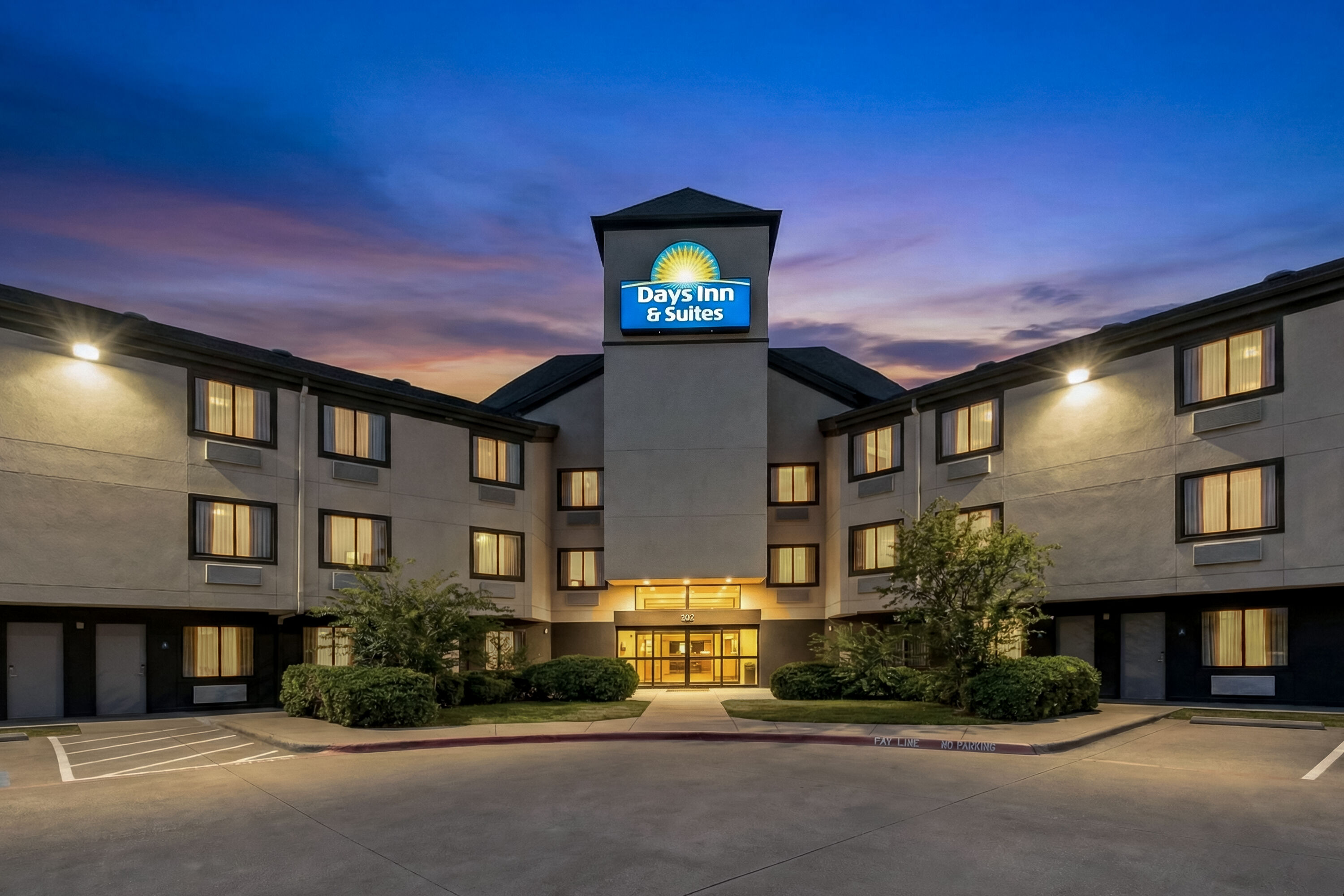 Exterior Night Image of Days Inn & Suites by Wyndham DeSoto hotel in DeSoto, Texas